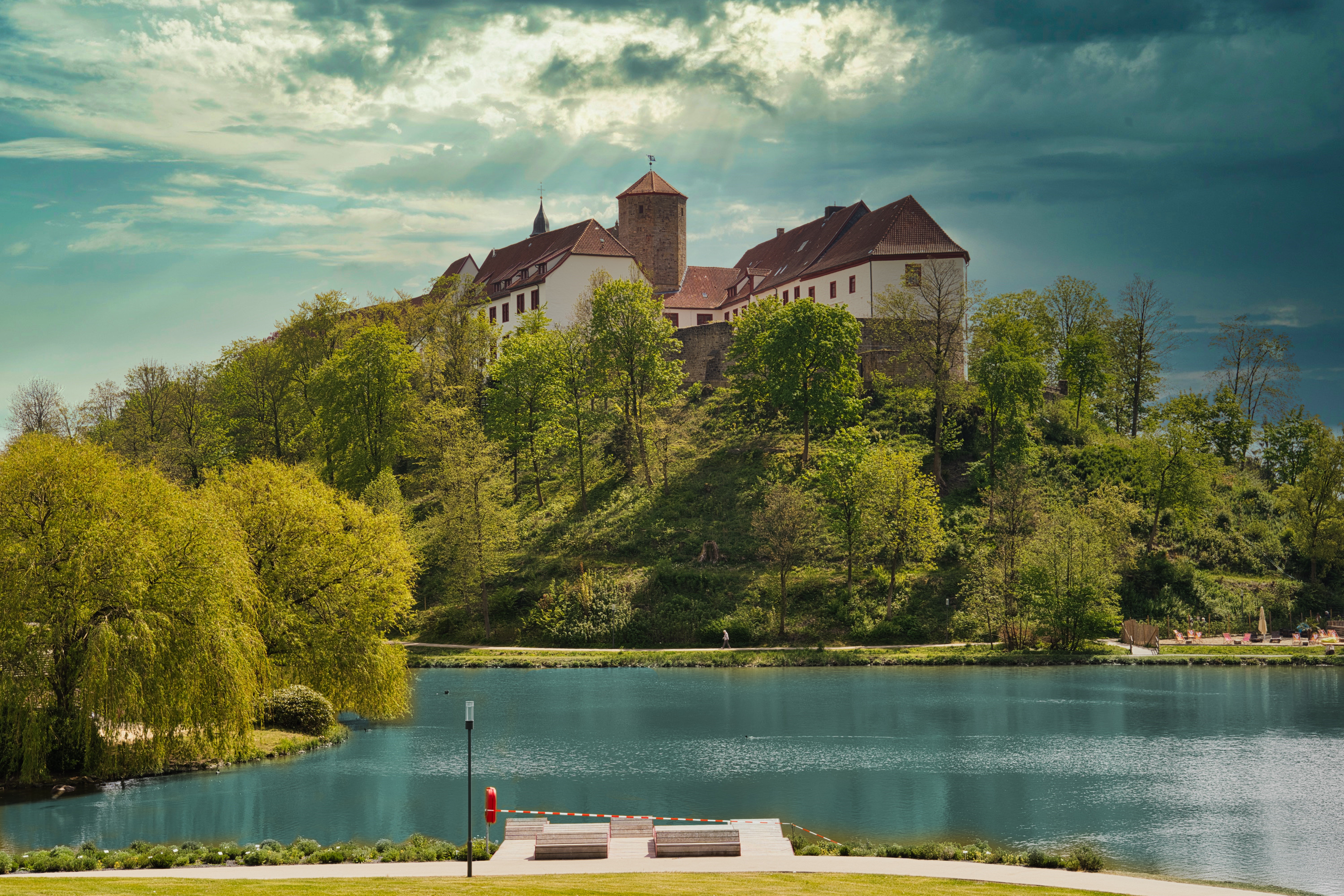 Castle on a hill overlooking a lake in Bad Iburg, Germany HD Wallpaper