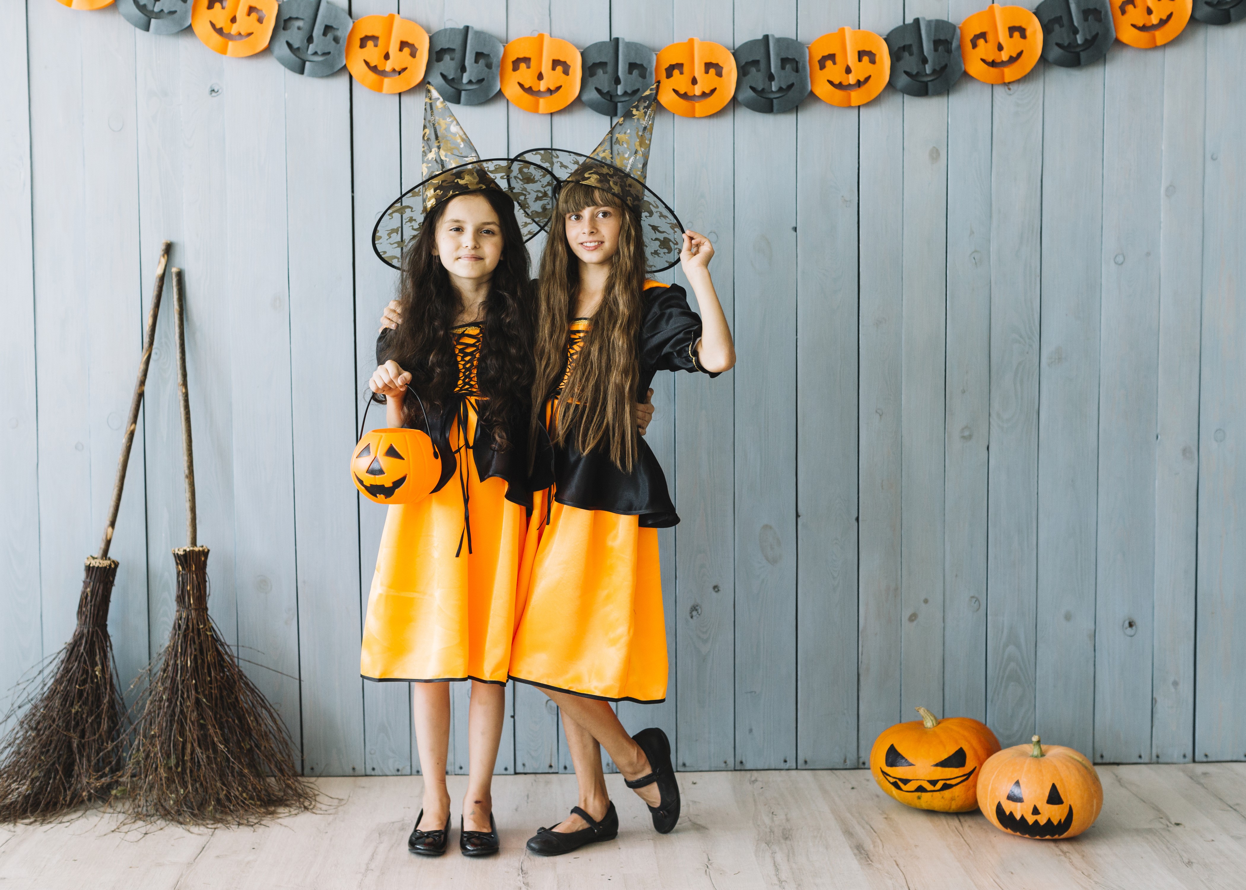 Two little girls in witch costumes with pumpkins HD Wallpaper