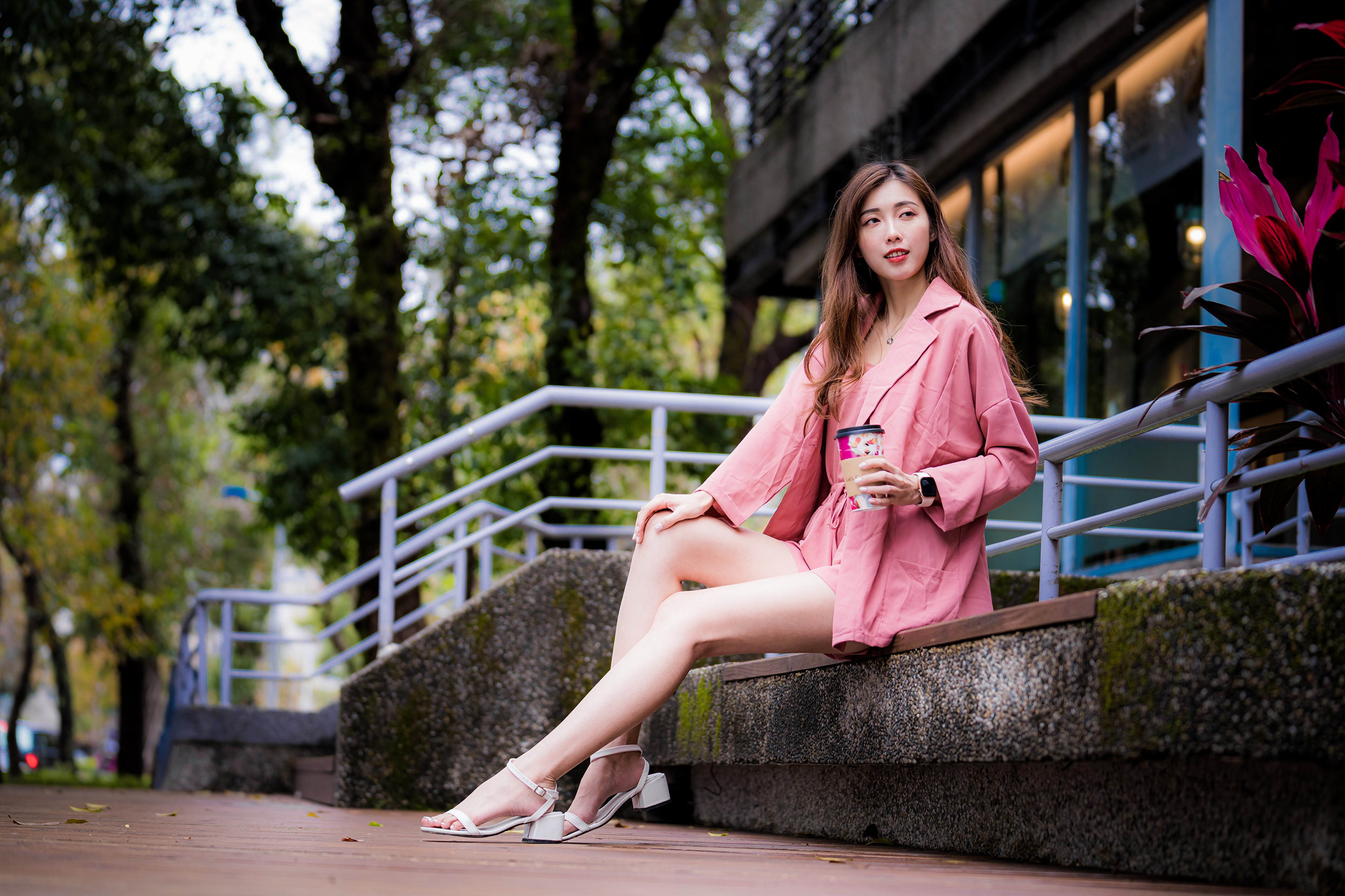 4K Asian Woman Sitting Outdoors in Pink Outfit HD Wallpaper