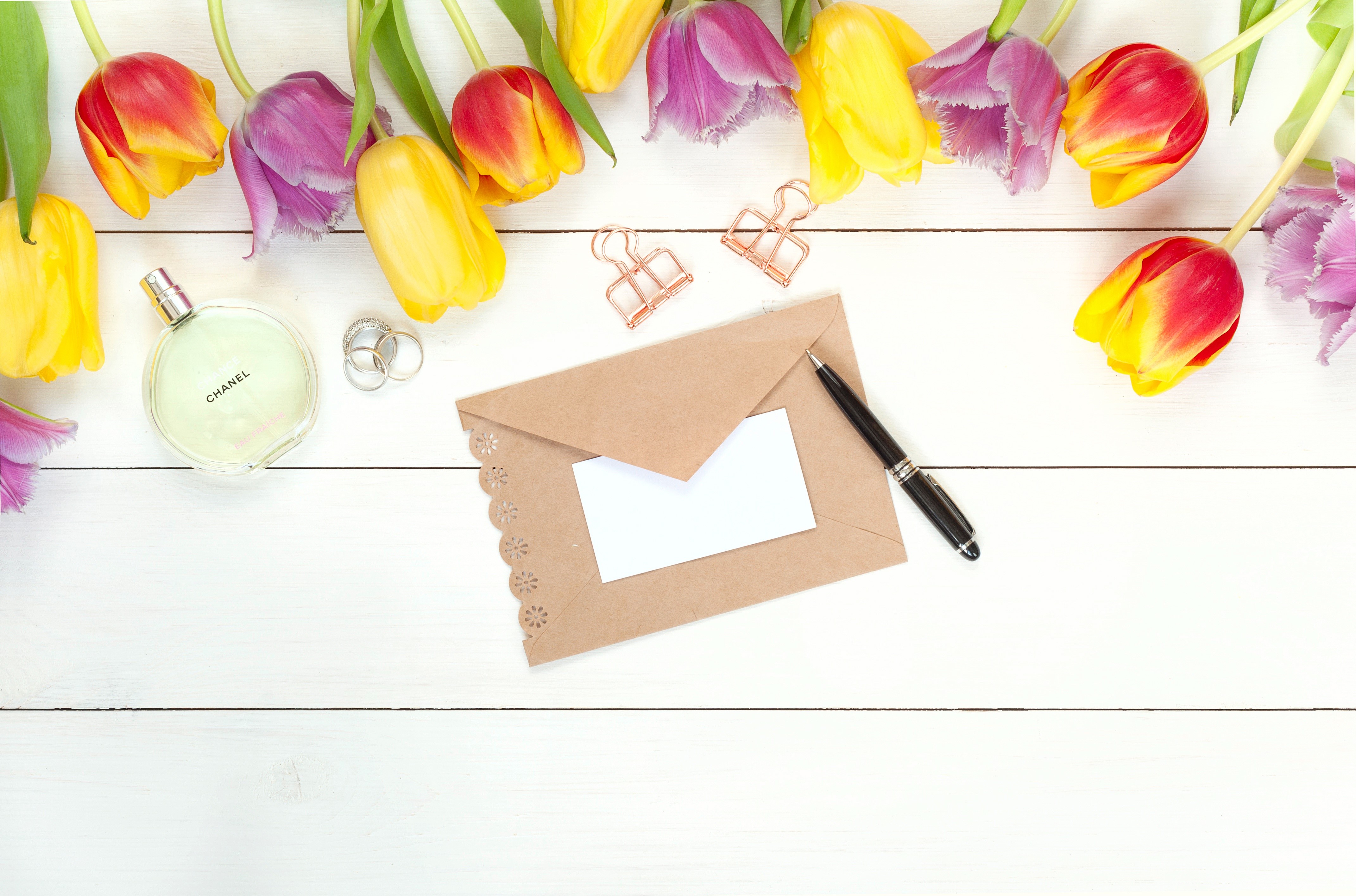 Tulips, Envelope, Pen, Perfume, and Rings on Wood HD Wallpaper