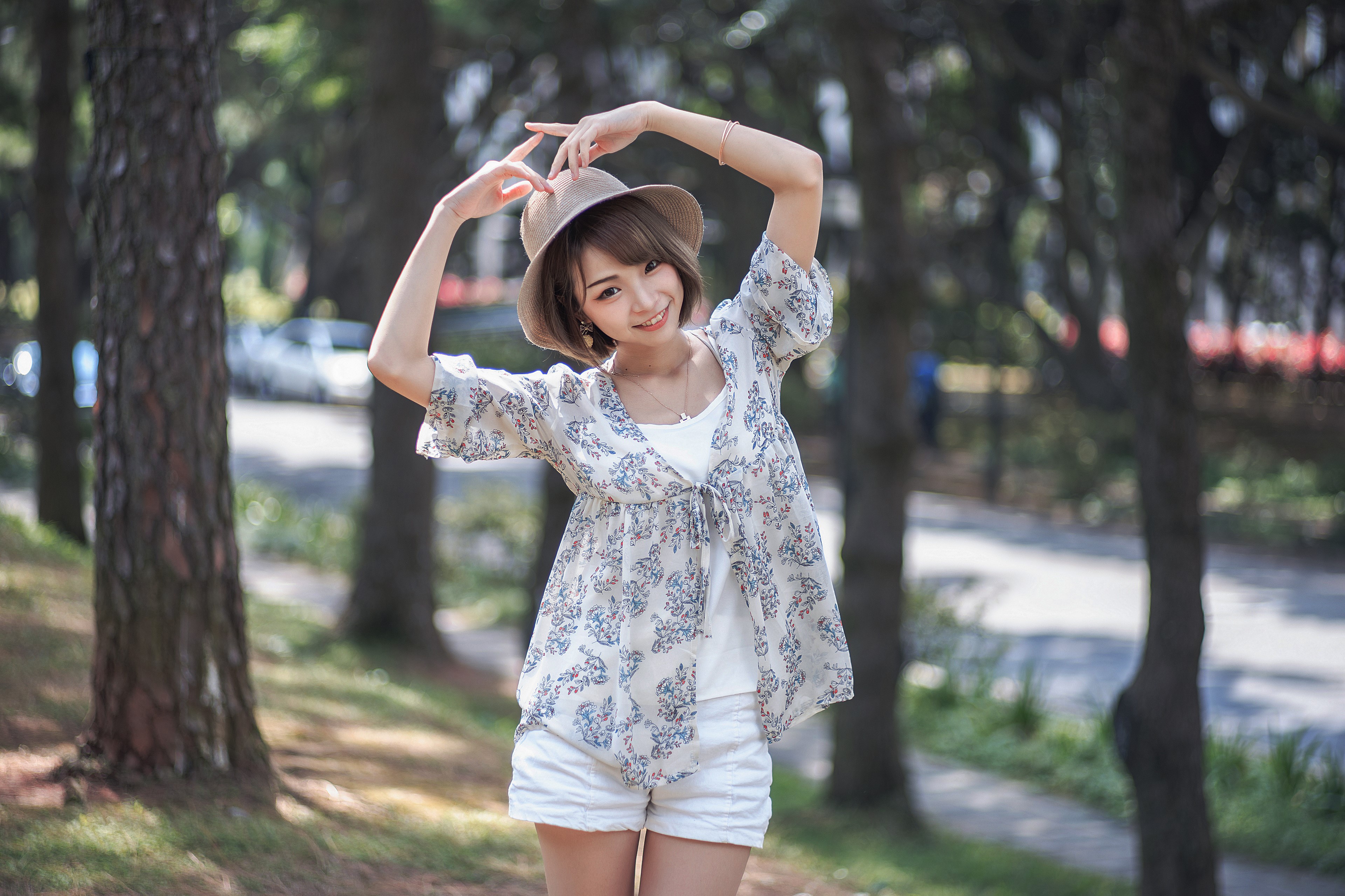 Asian woman in hat posing outdoors HD Wallpaper