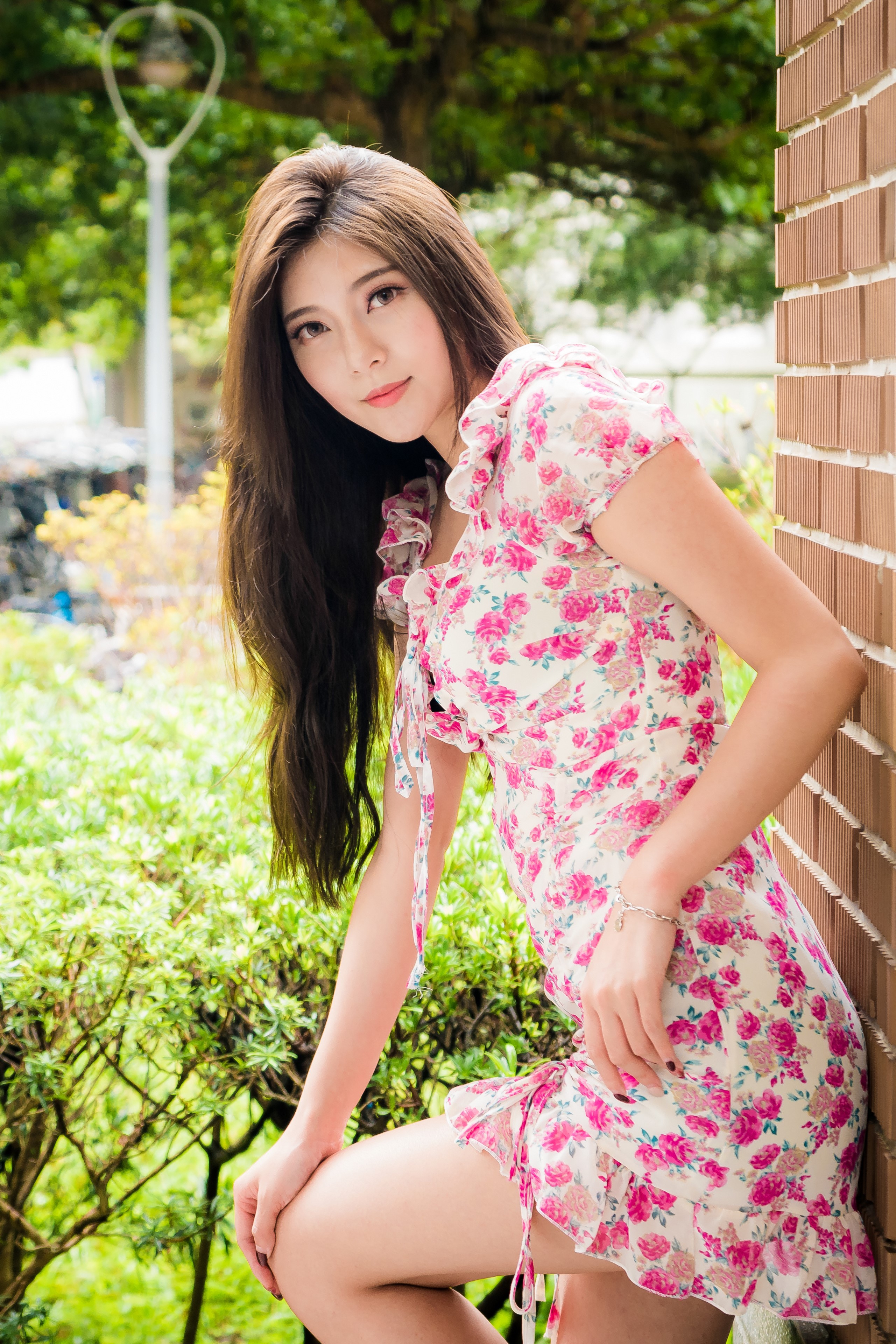 Asian woman in floral dress posing outdoors HD Phone Wallpaper