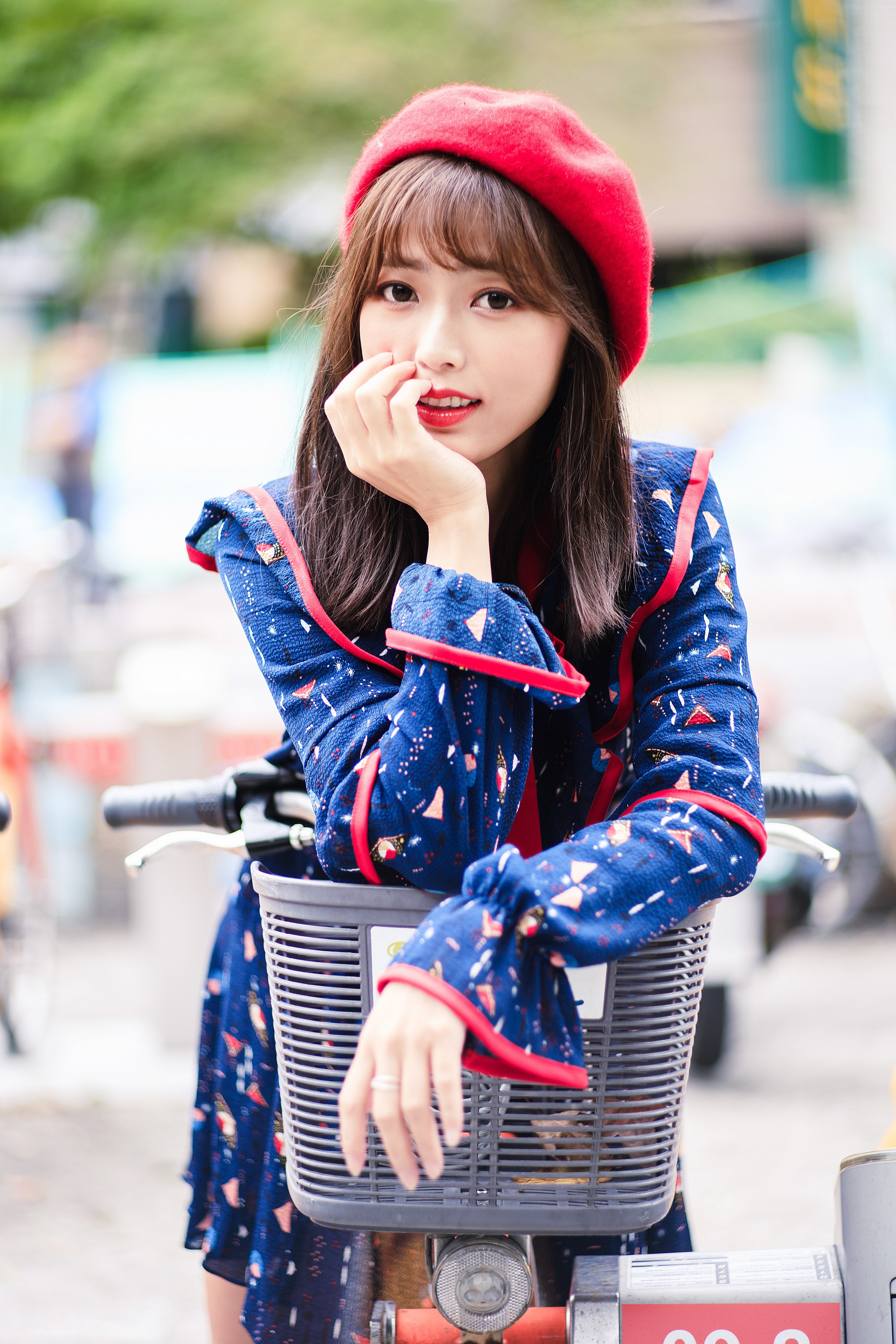 Woman in red beret and blue dress on a bicycle HD Phone Wallpaper
