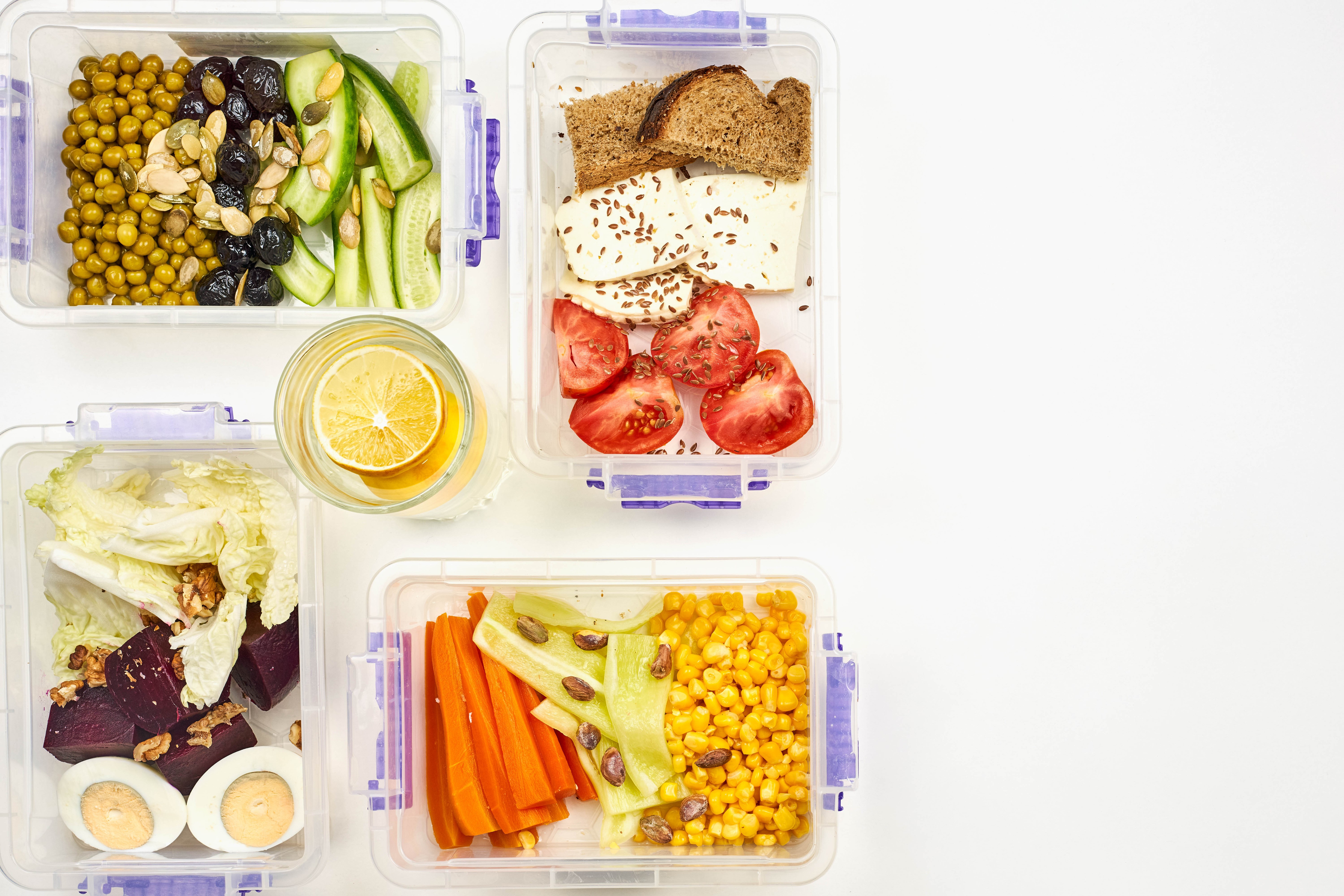 Meal prep containers with bread, cheese, tomatoes, eggs, and vegetables HD Wallpaper