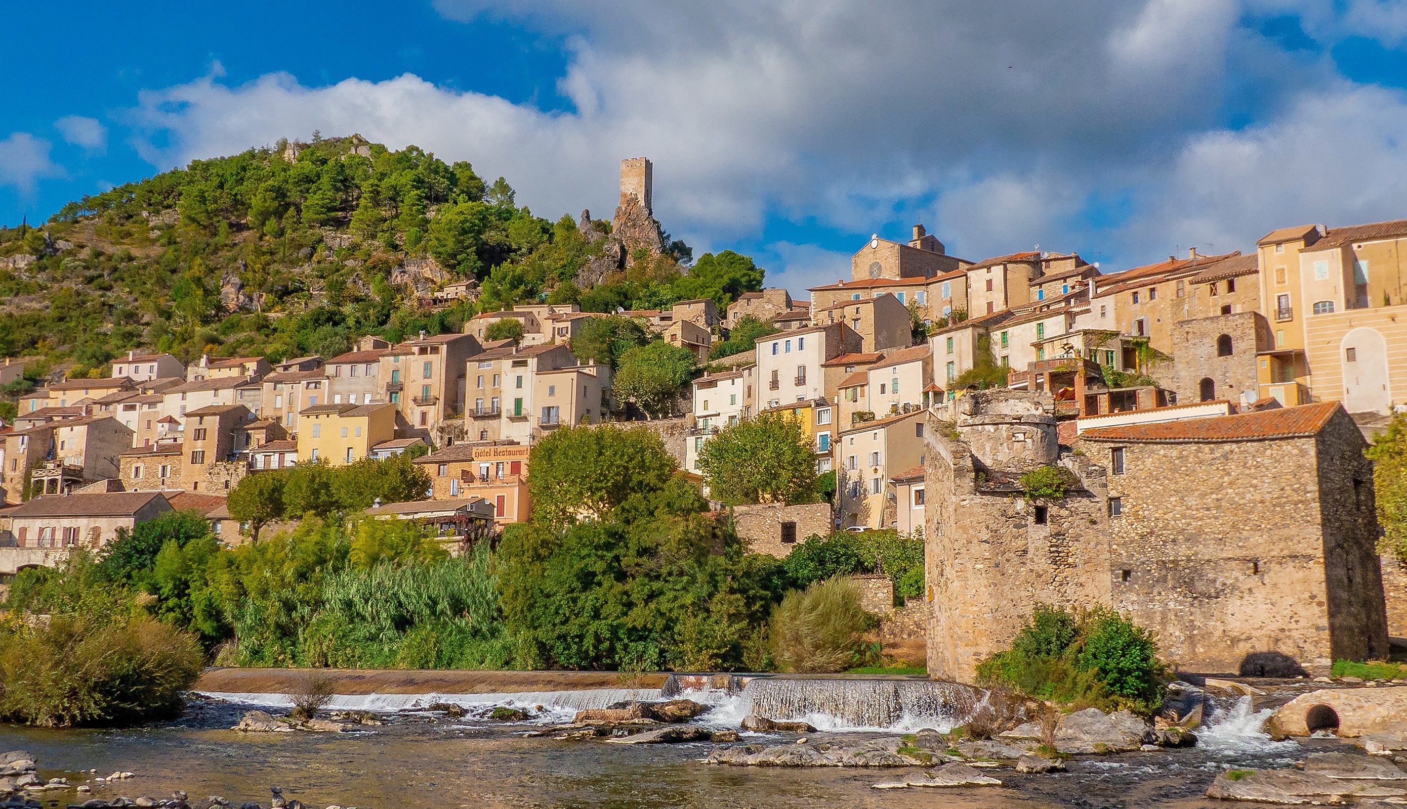 Roquebrun village with castle ruins and river in France HD Wallpaper