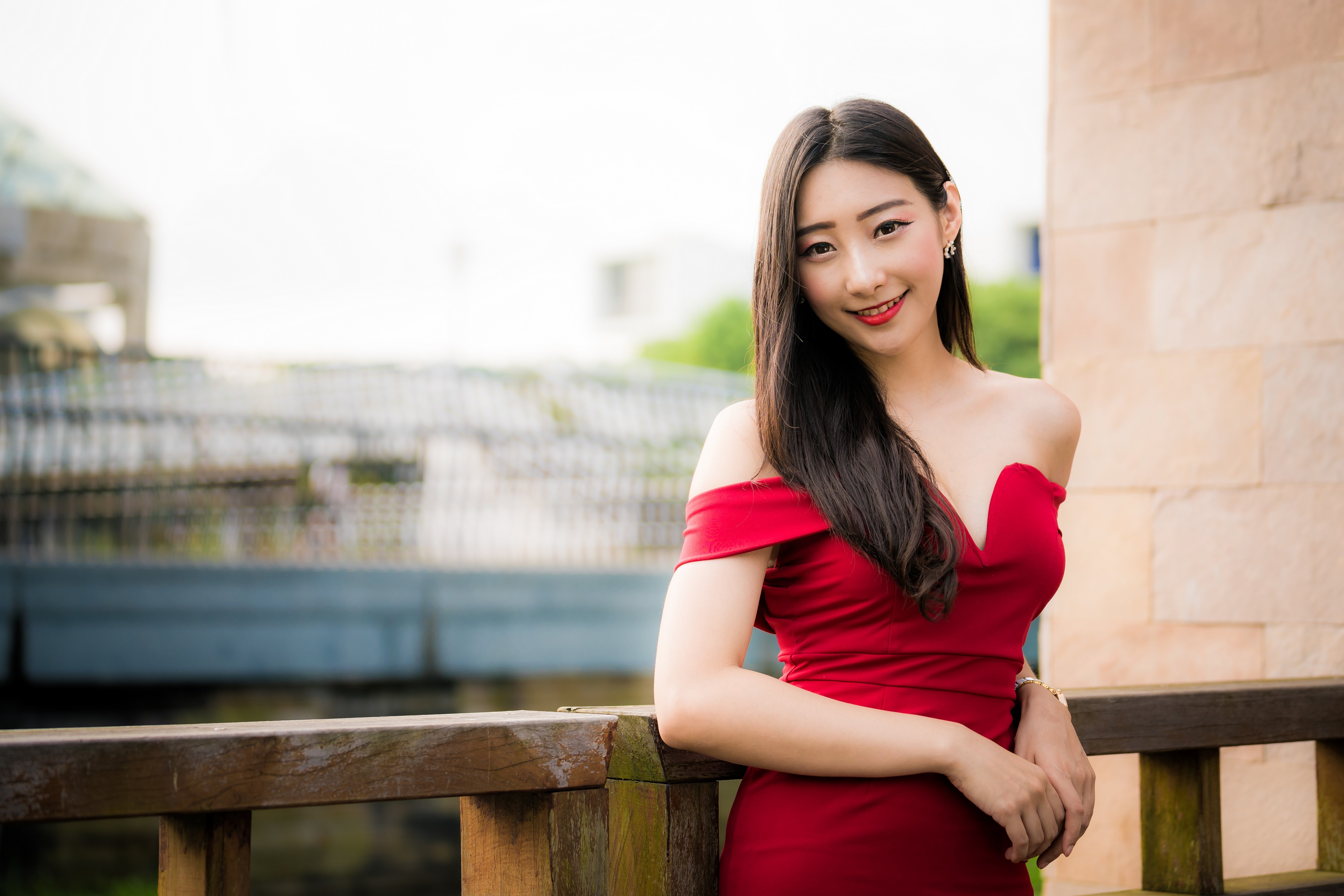 Asian woman in red dress smiling HD Wallpaper
