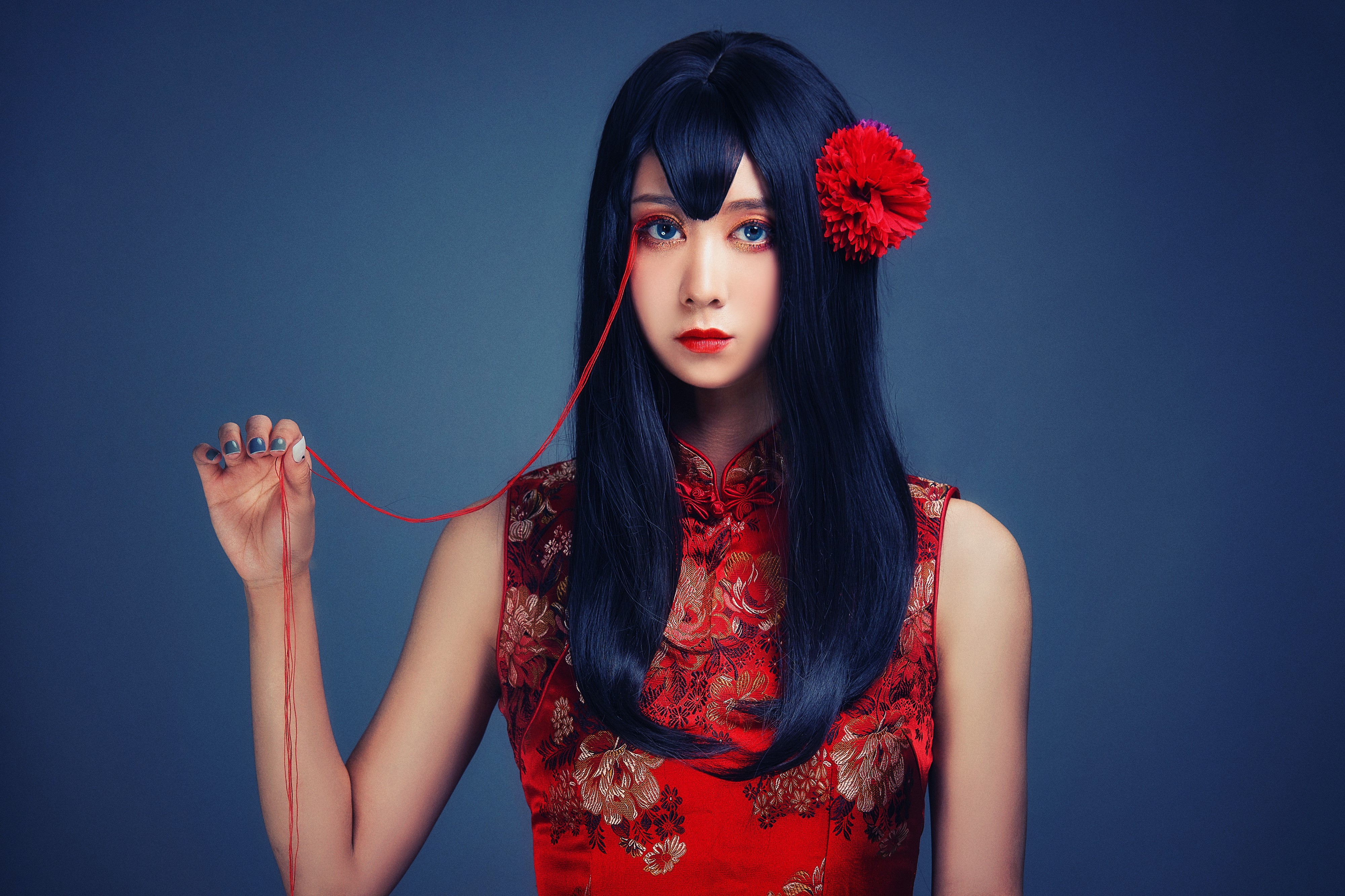Asian woman with red flower in hair and red dress HD Wallpaper