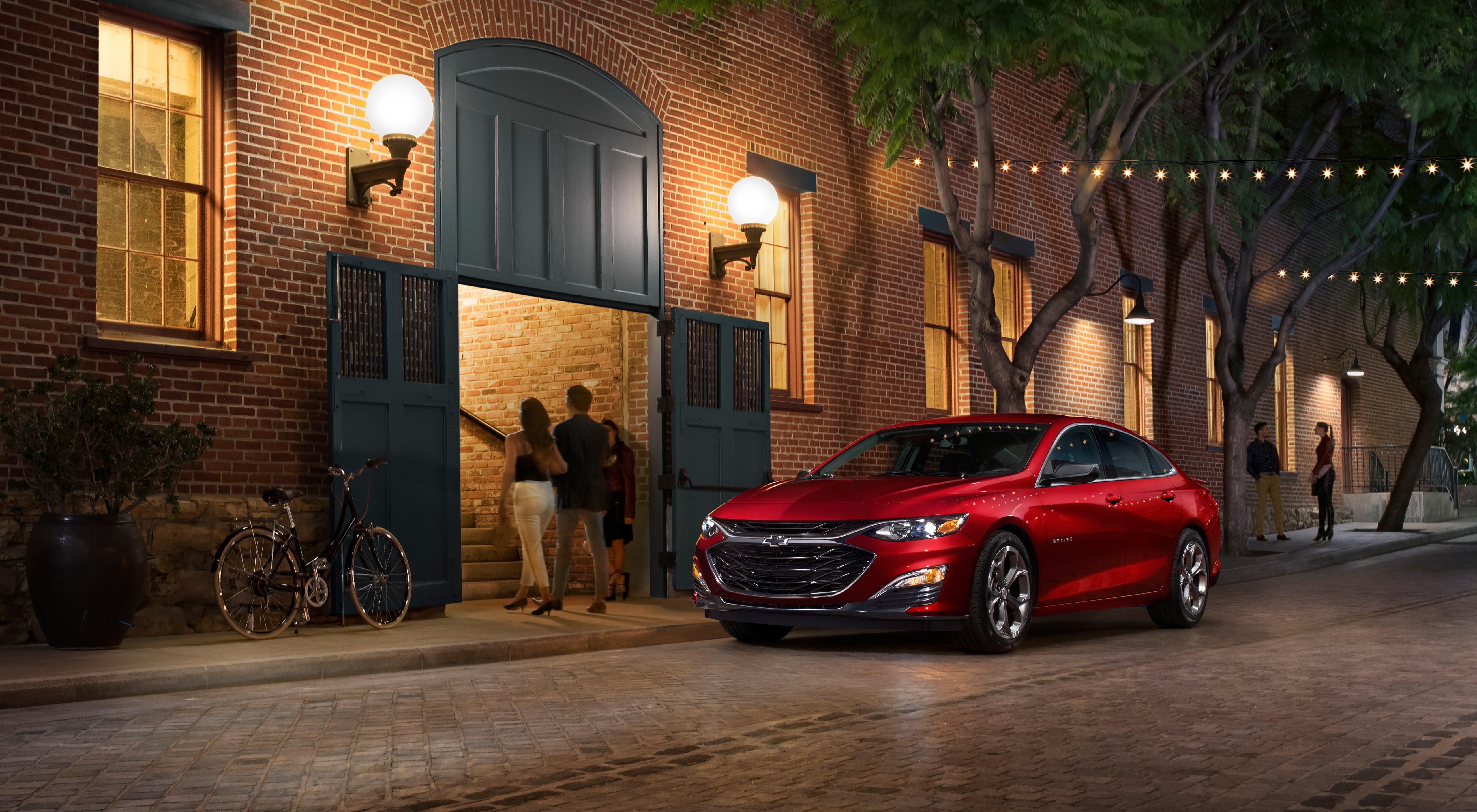 Red Chevrolet Malibu RS Sedan on a Brick Street at Night HD Wallpaper