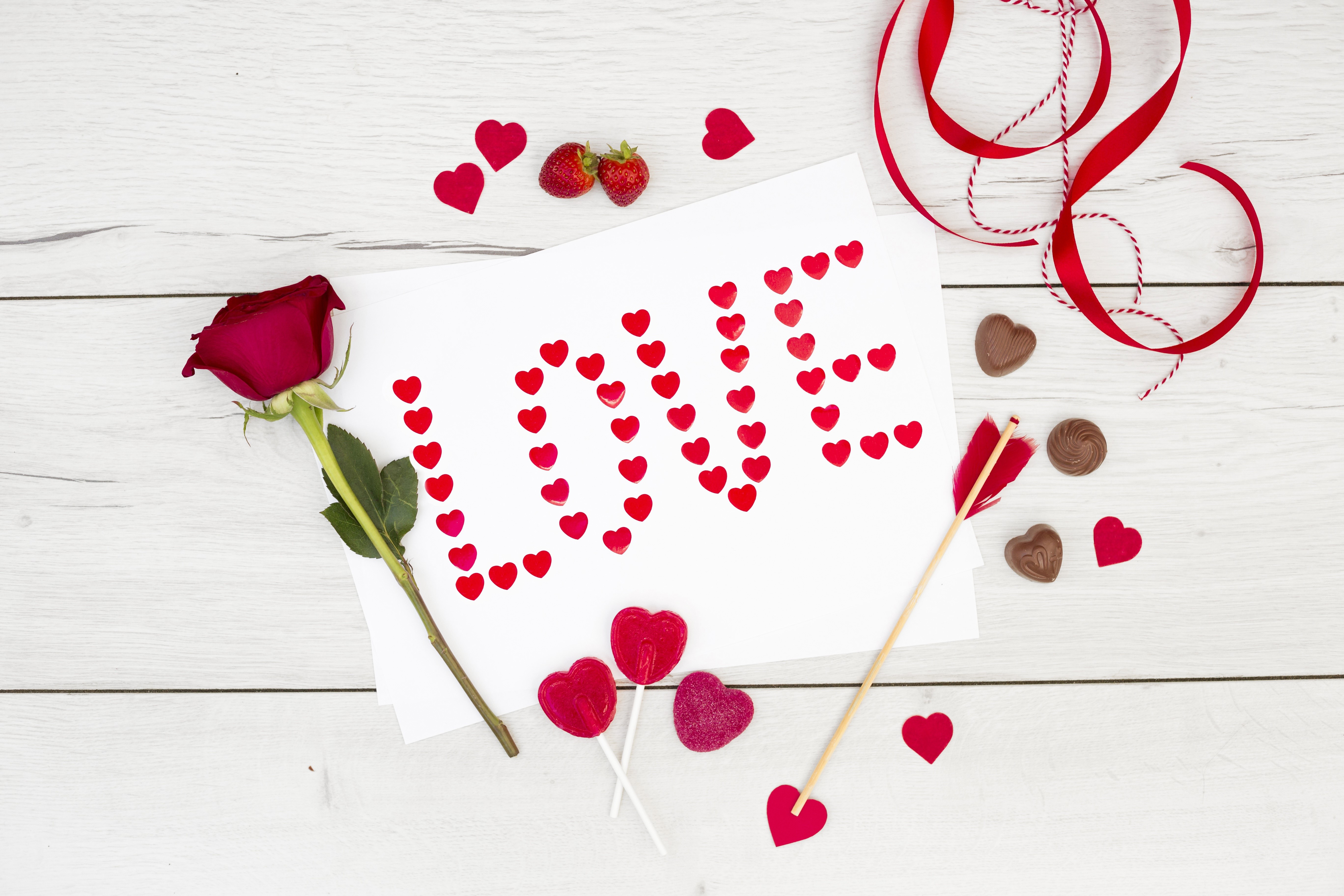 Valentine's Day arrangement with rose, hearts, and chocolates HD Wallpaper