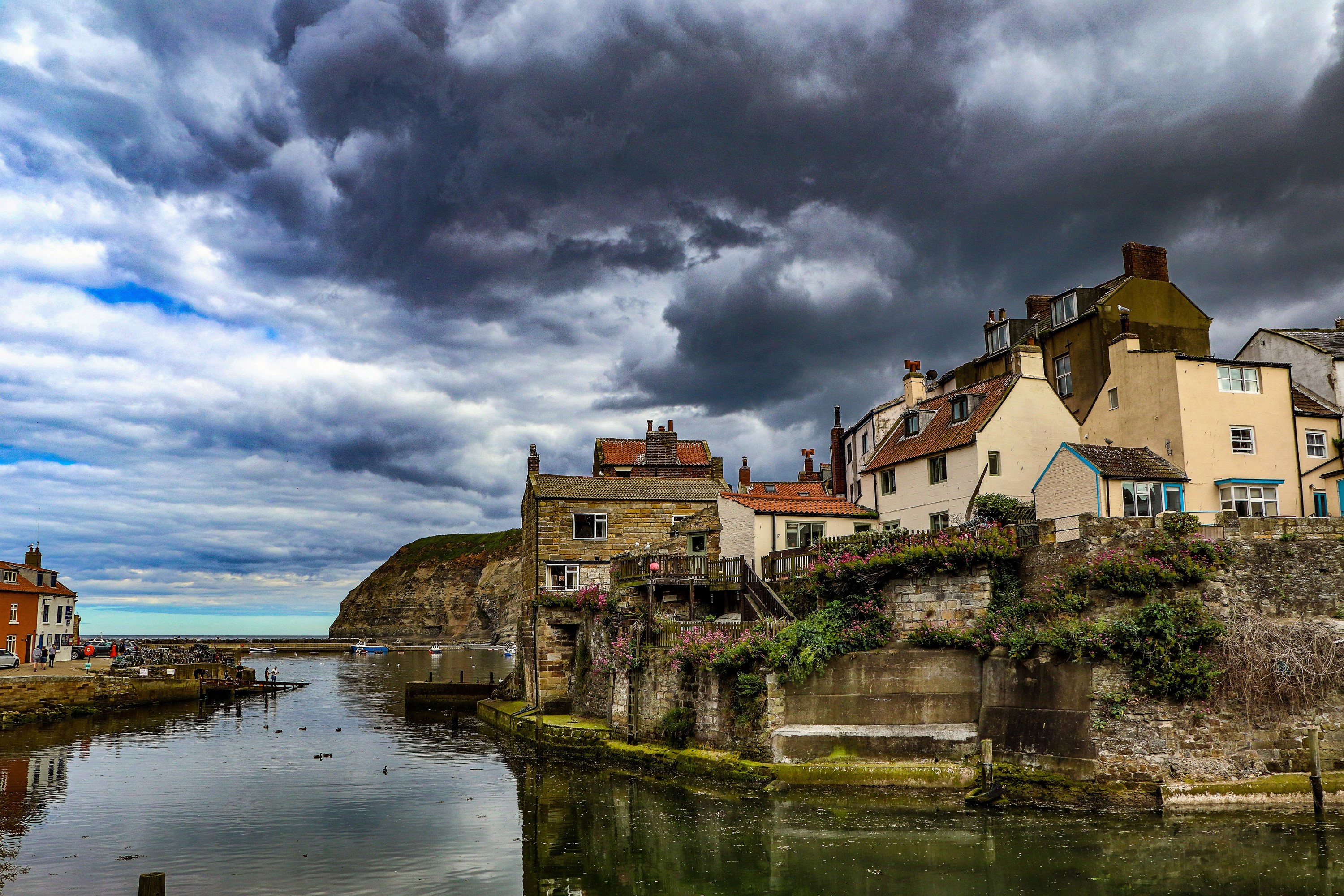 Village of Staithes, Yorkshire, England with dramatic clouds HD Wallpaper