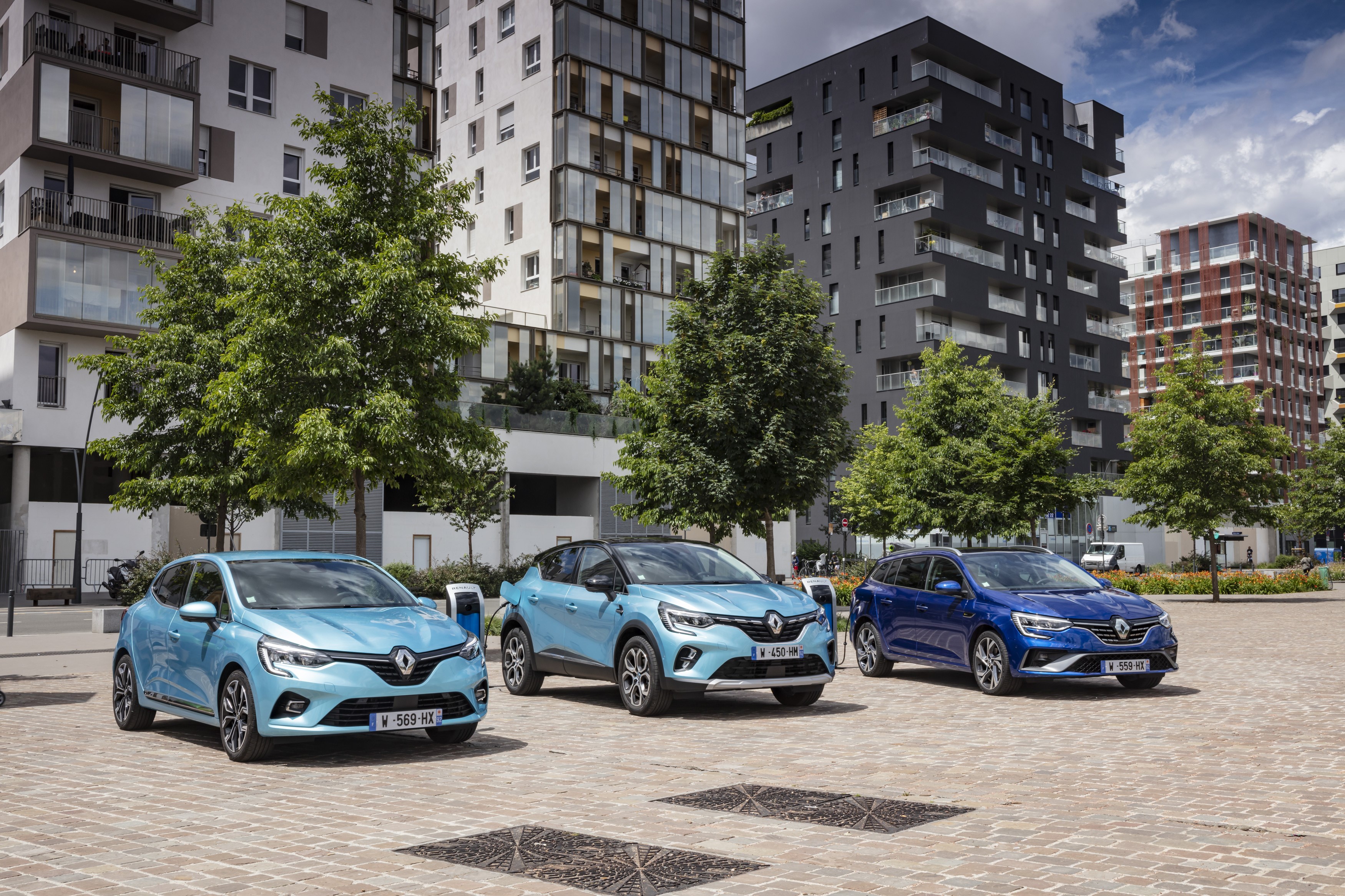 Three Renault cars parked in front of modern buildings HD Wallpaper