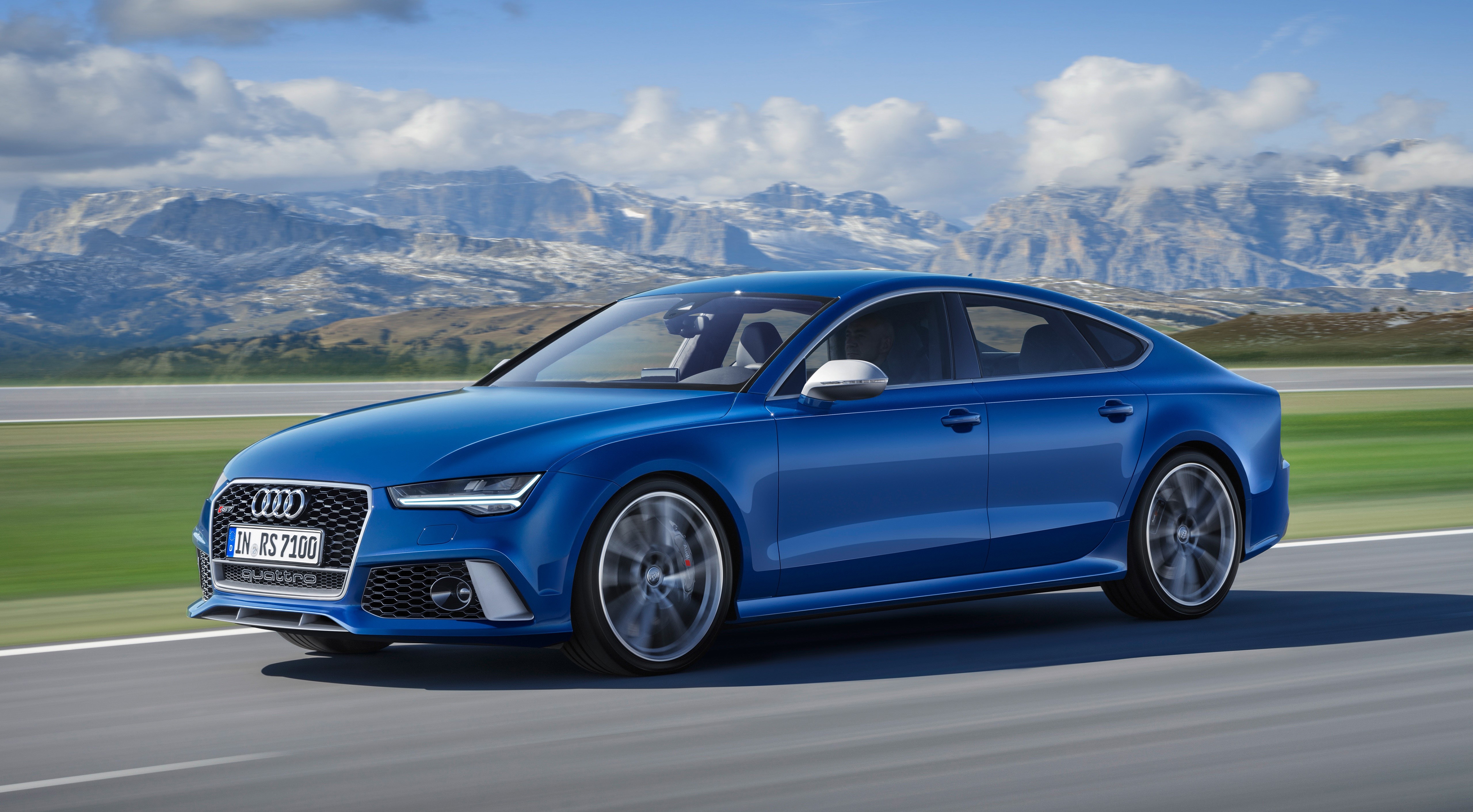 Blue Audi RS7 Sportback performance driving on a road HD Wallpaper