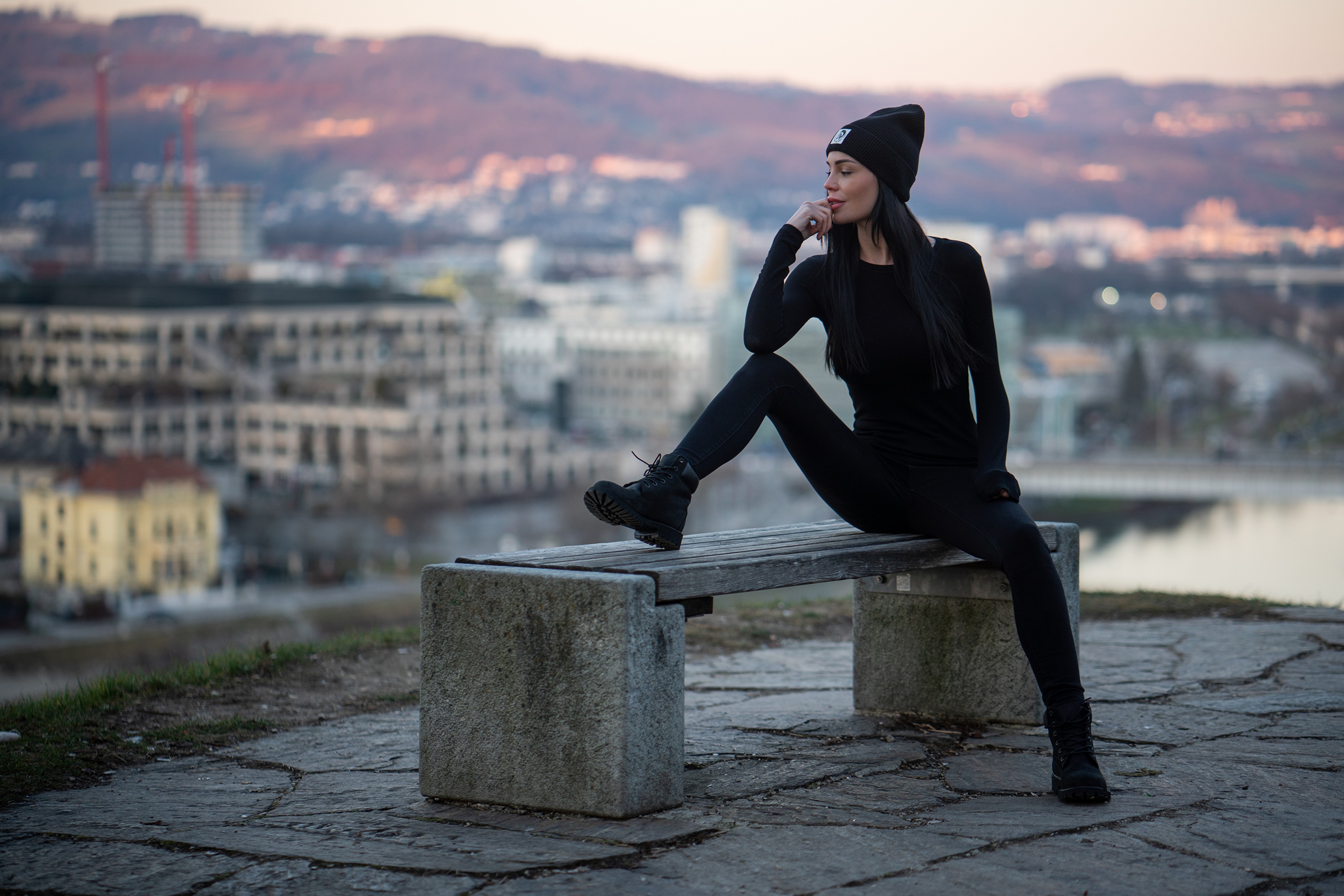 Brunette girl in winter hat sitting on bench HD Wallpaper
