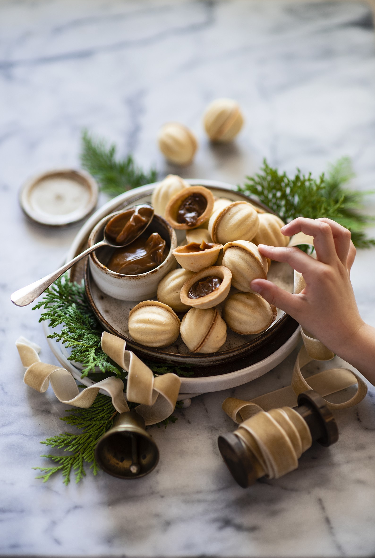 Sweet nut-shaped pastries with caramel filling and festive decor HD Phone Wallpaper