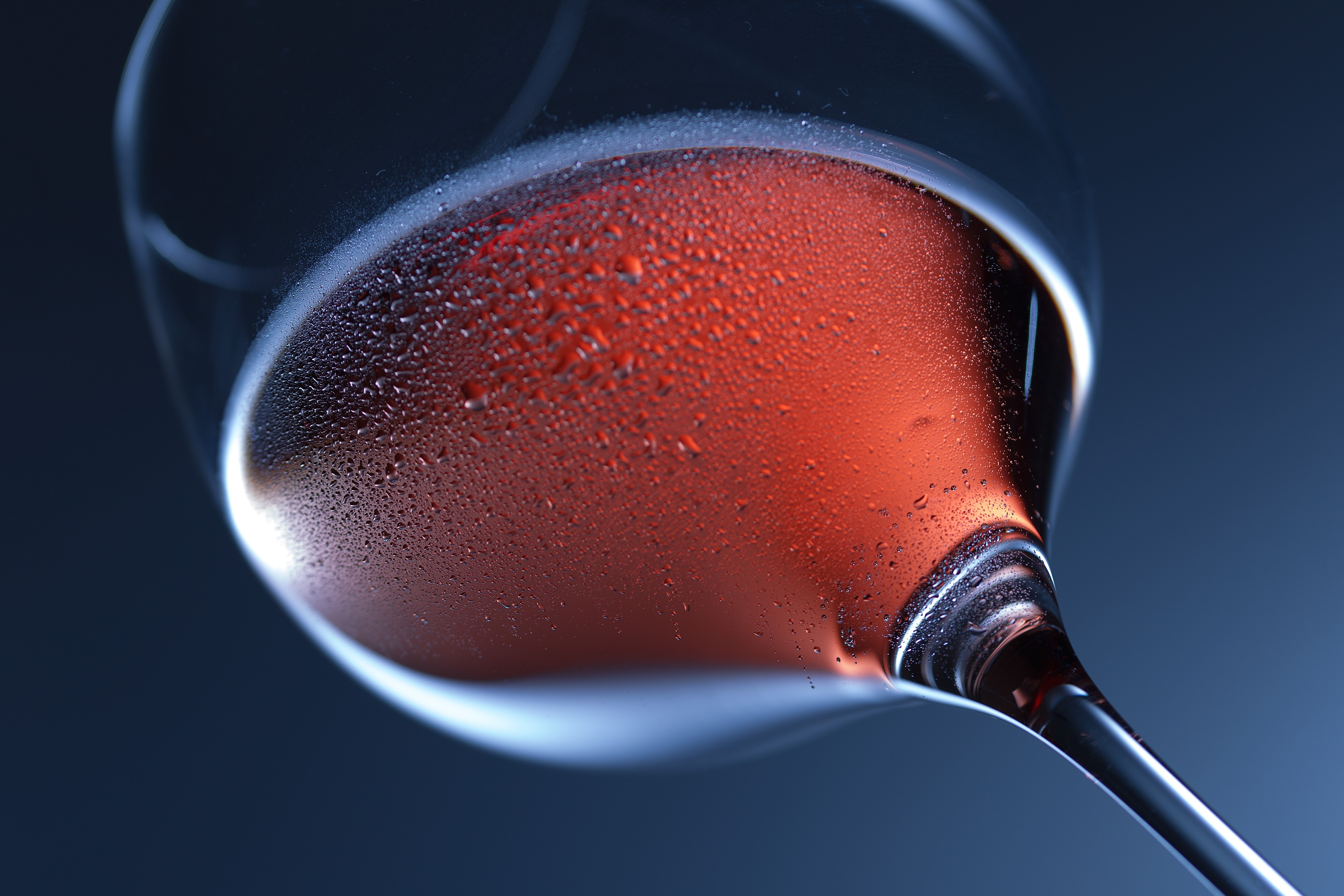 Close-up of Rosé Wine in a Glass with Drops HD Wallpaper