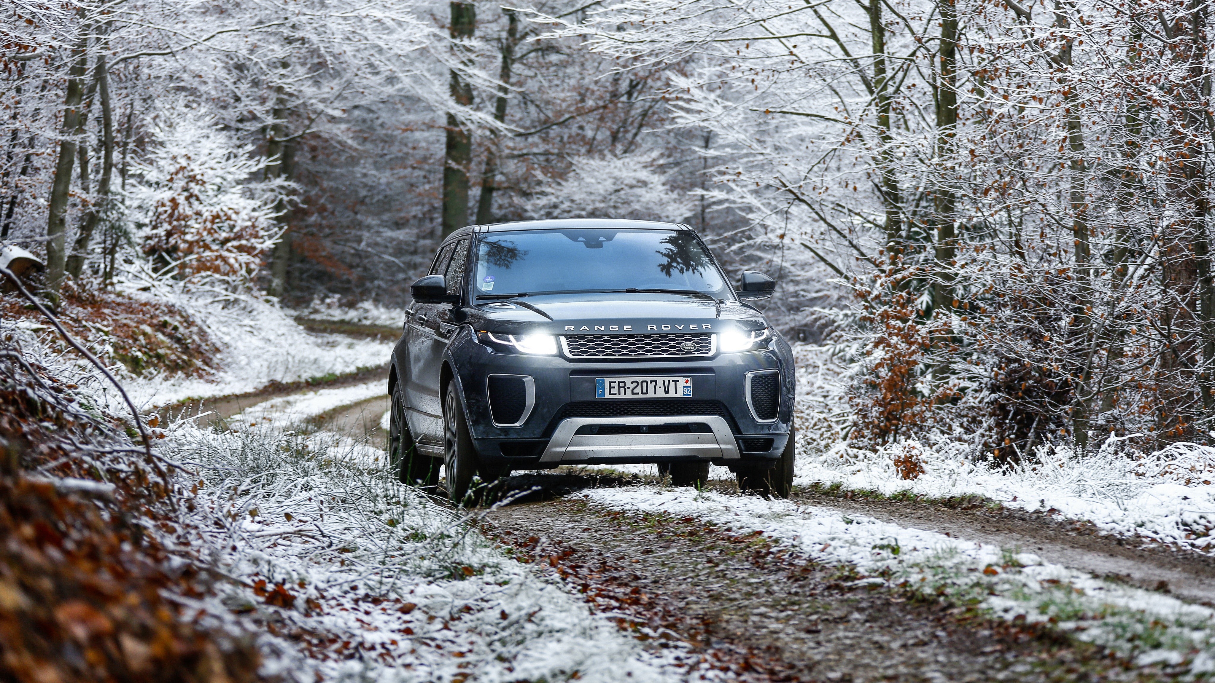 Range Rover Evoque Autobiography Si4 on snowy forest road HD Wallpaper