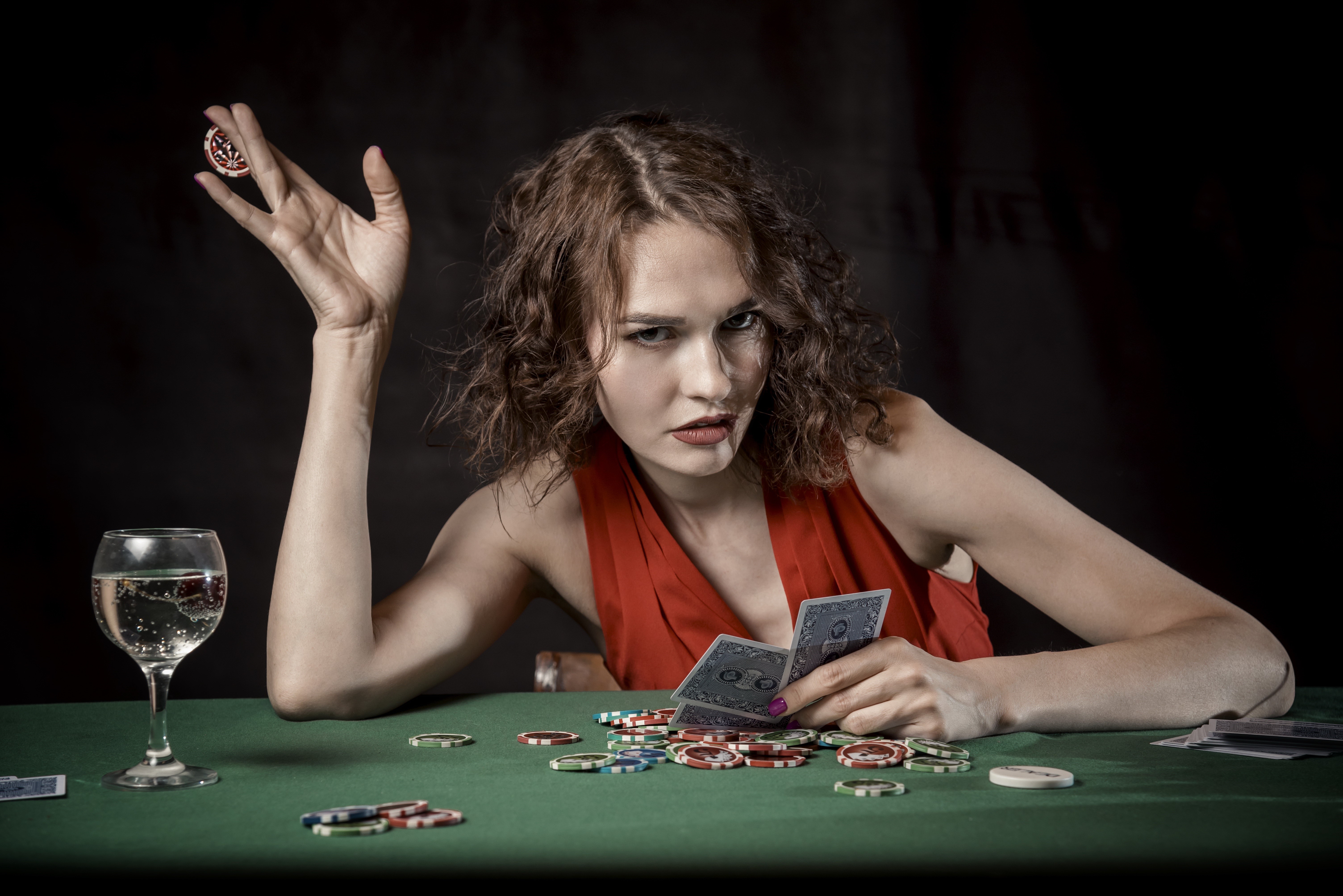 Woman playing cards with casino tokens and a drink HD Wallpaper