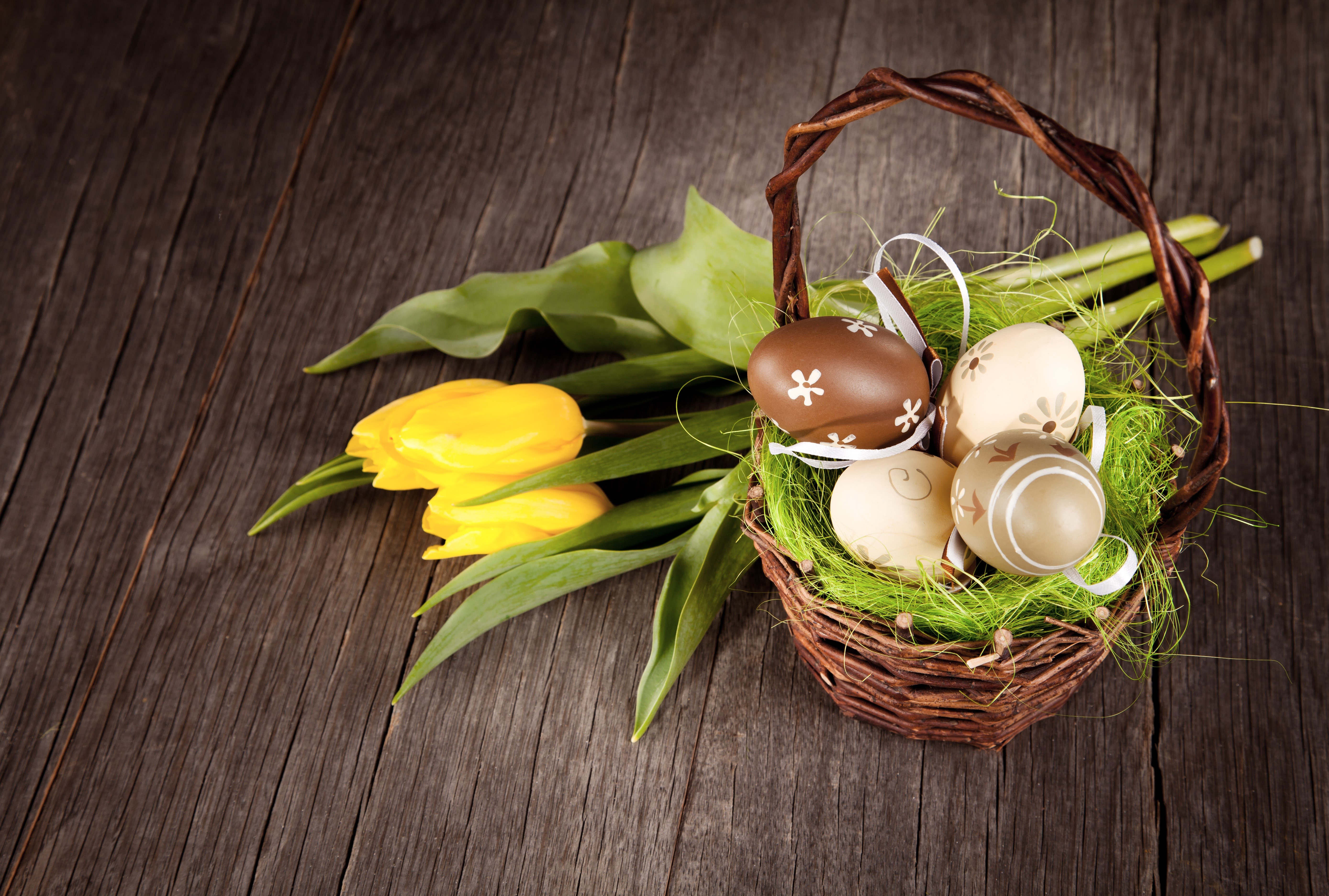 Easter eggs in a basket with yellow tulips HD Wallpaper