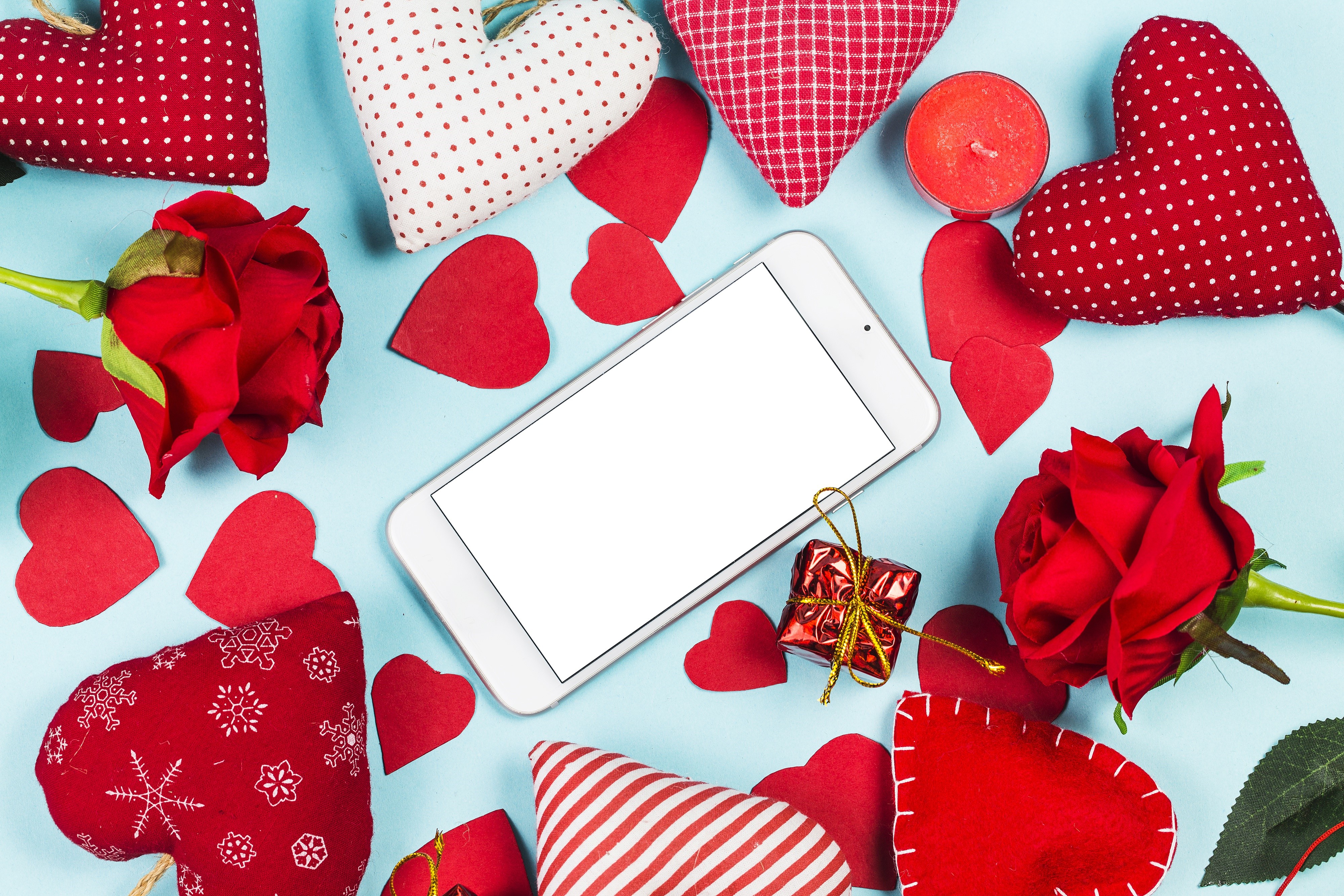 Smartphone surrounded by Valentine's Day decorations HD Wallpaper