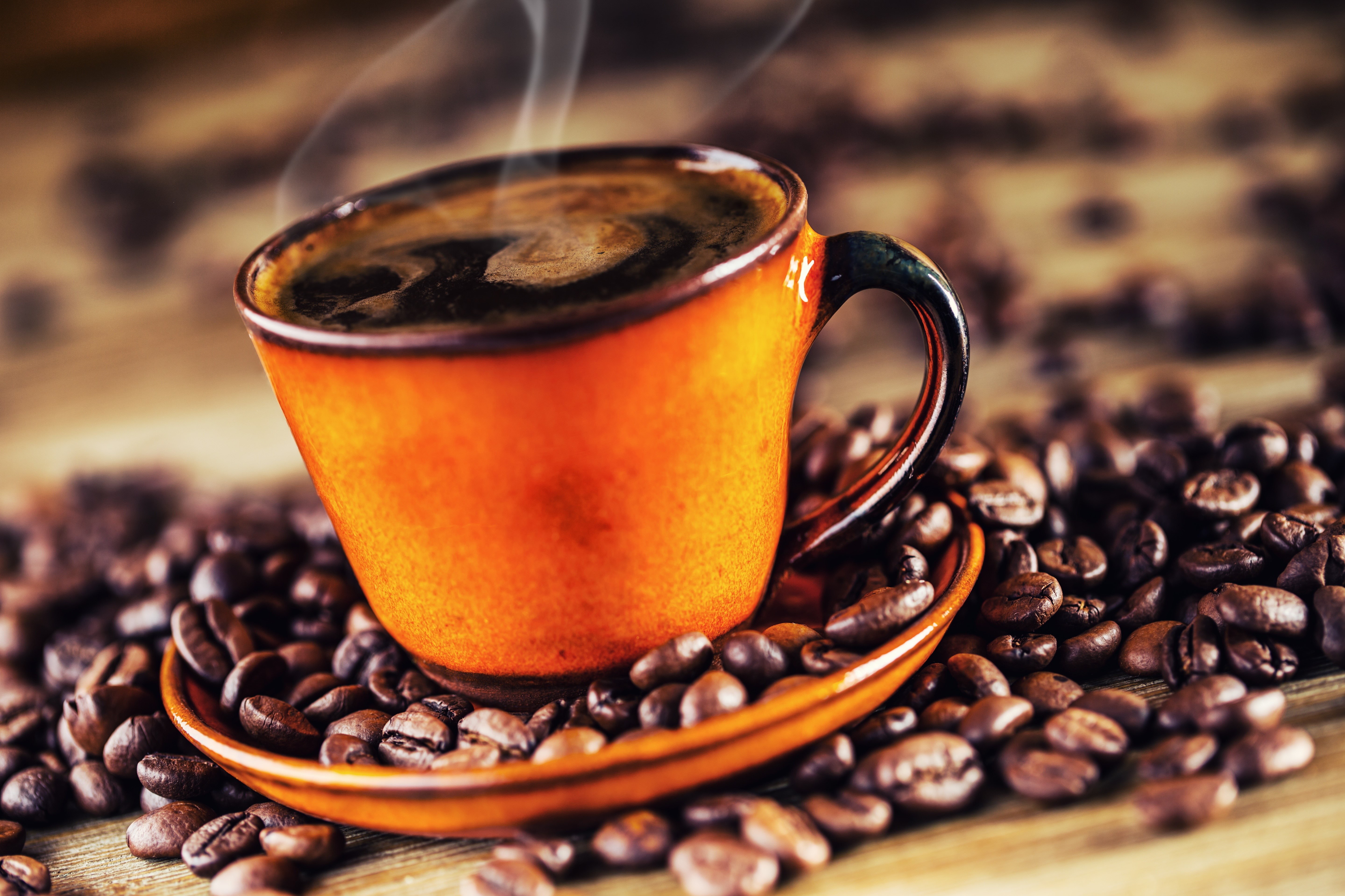Steaming Cup of Coffee Surrounded by Beans HD Wallpaper