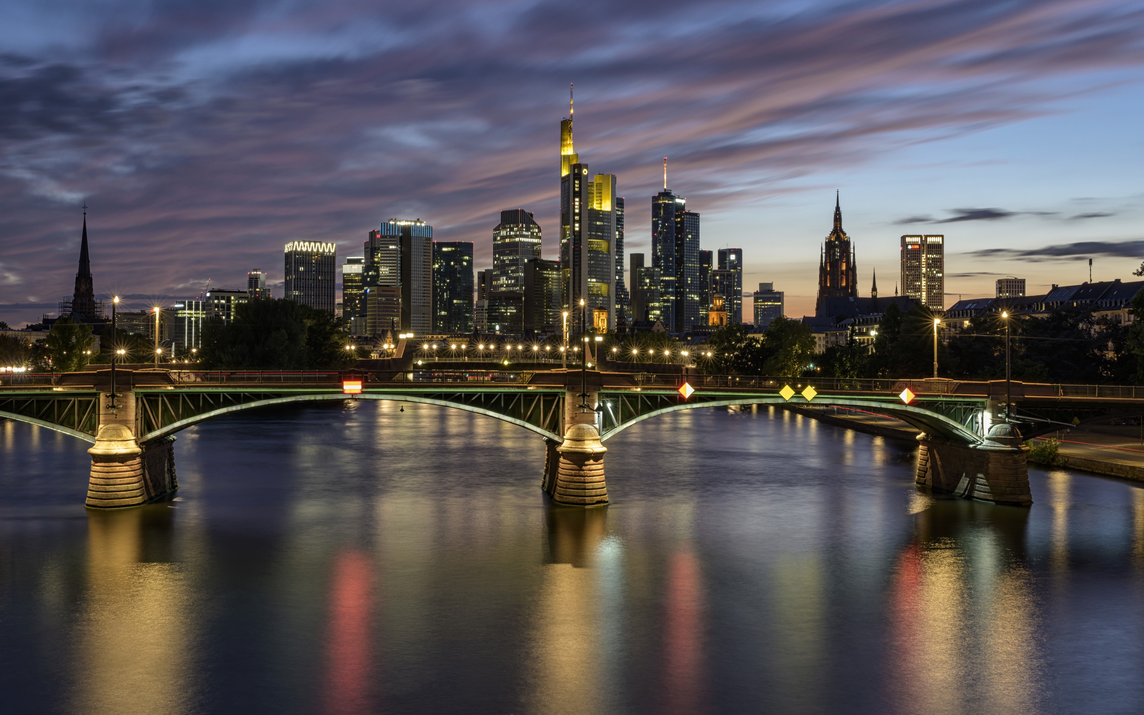 Frankfurt skyline and bridge over river at dusk HD Wallpaper