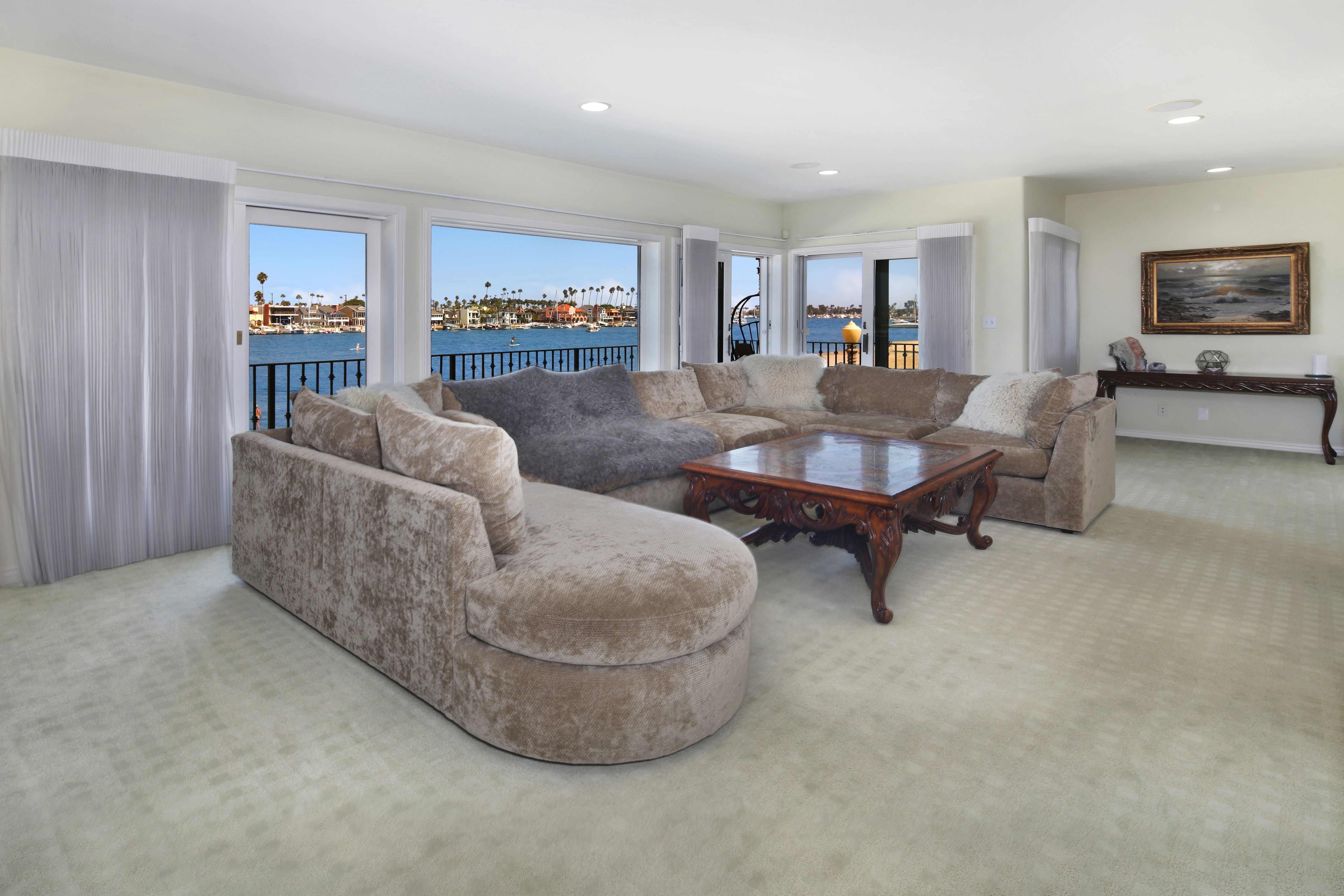 Living room with sectional sofa and water view HD Wallpaper