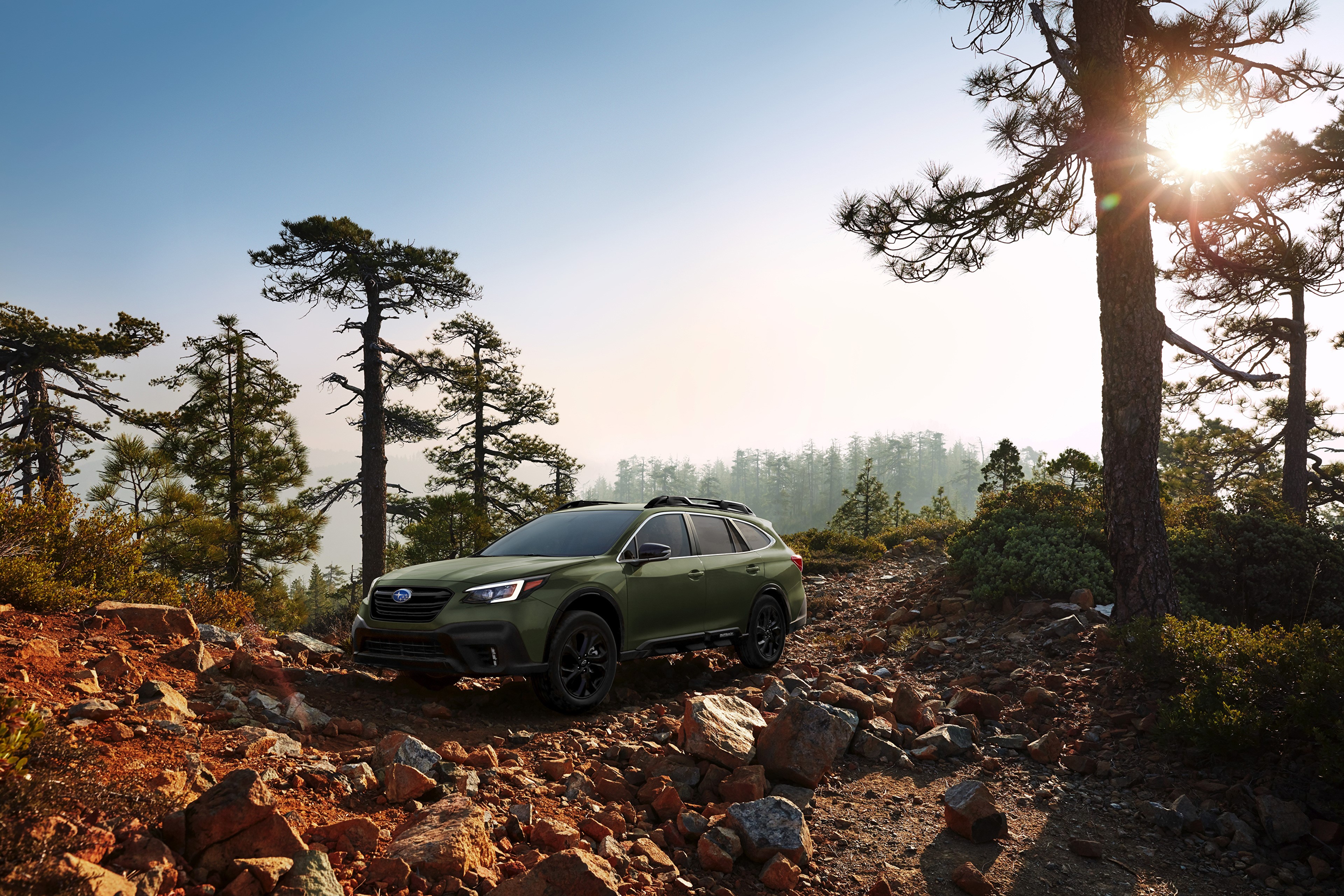 Green Subaru Outback Onyx Edition XT on rocky terrain HD Wallpaper