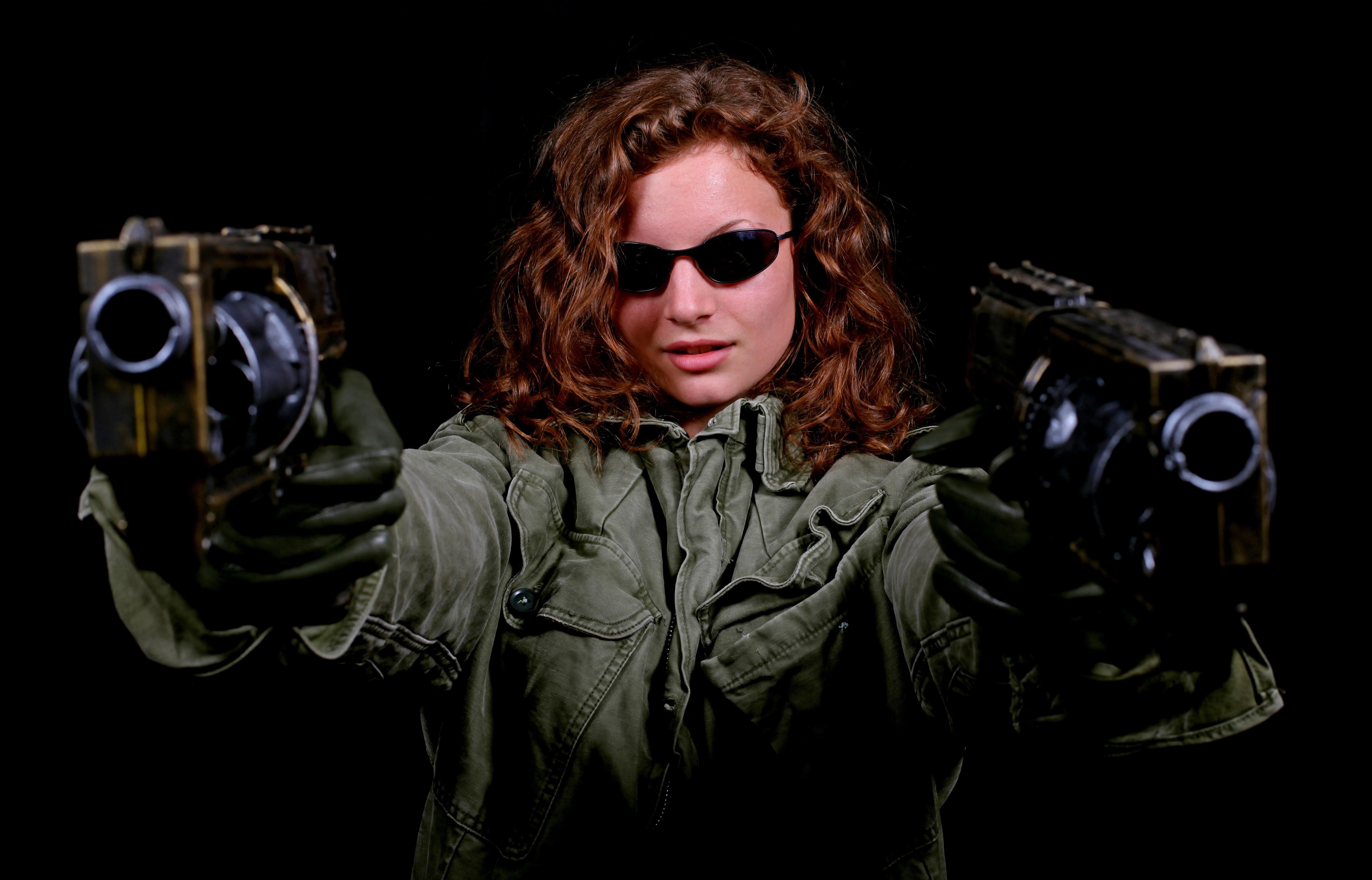 Woman with two pistols on black background HD Wallpaper
