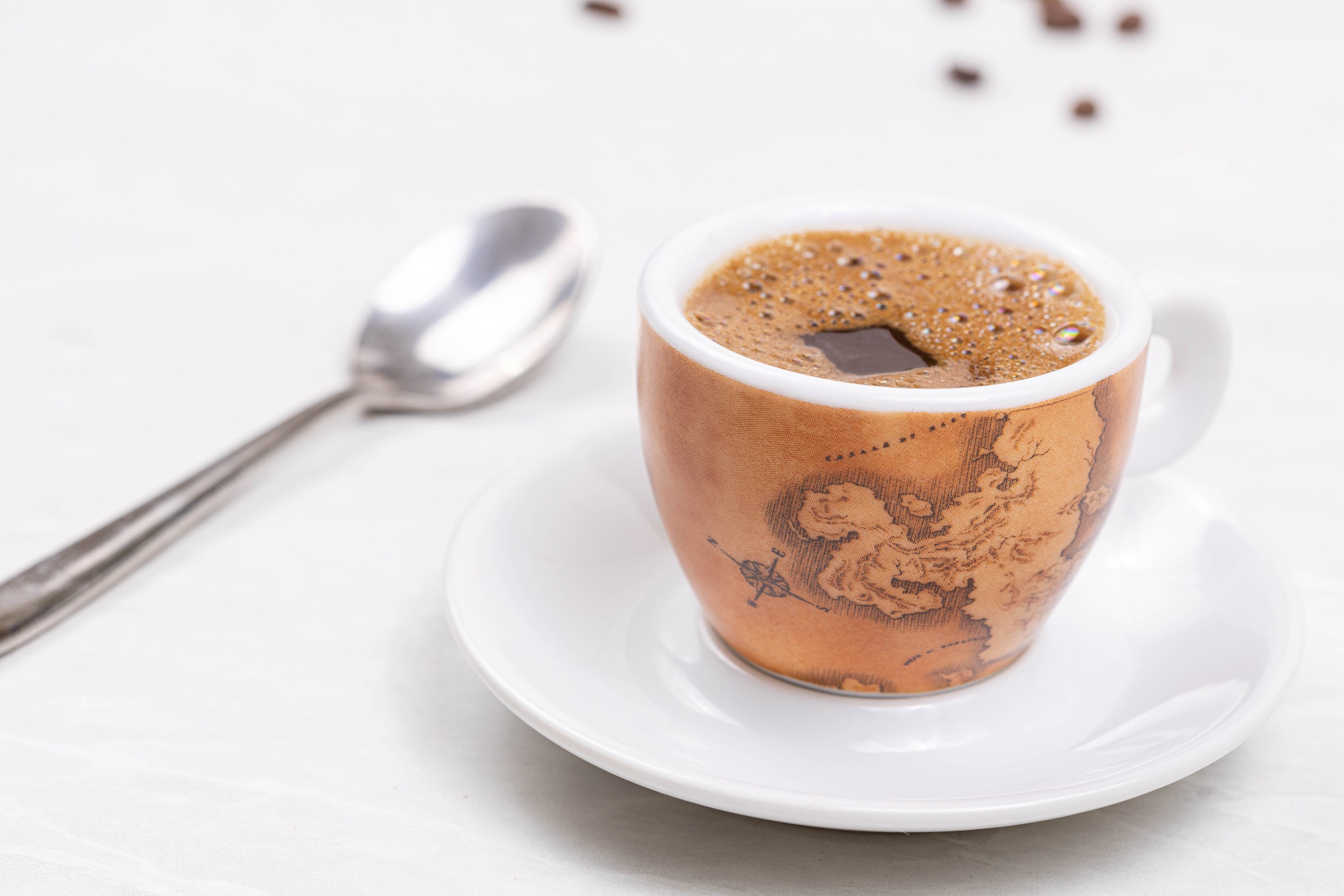 Espresso cup with map design and spoon HD Wallpaper