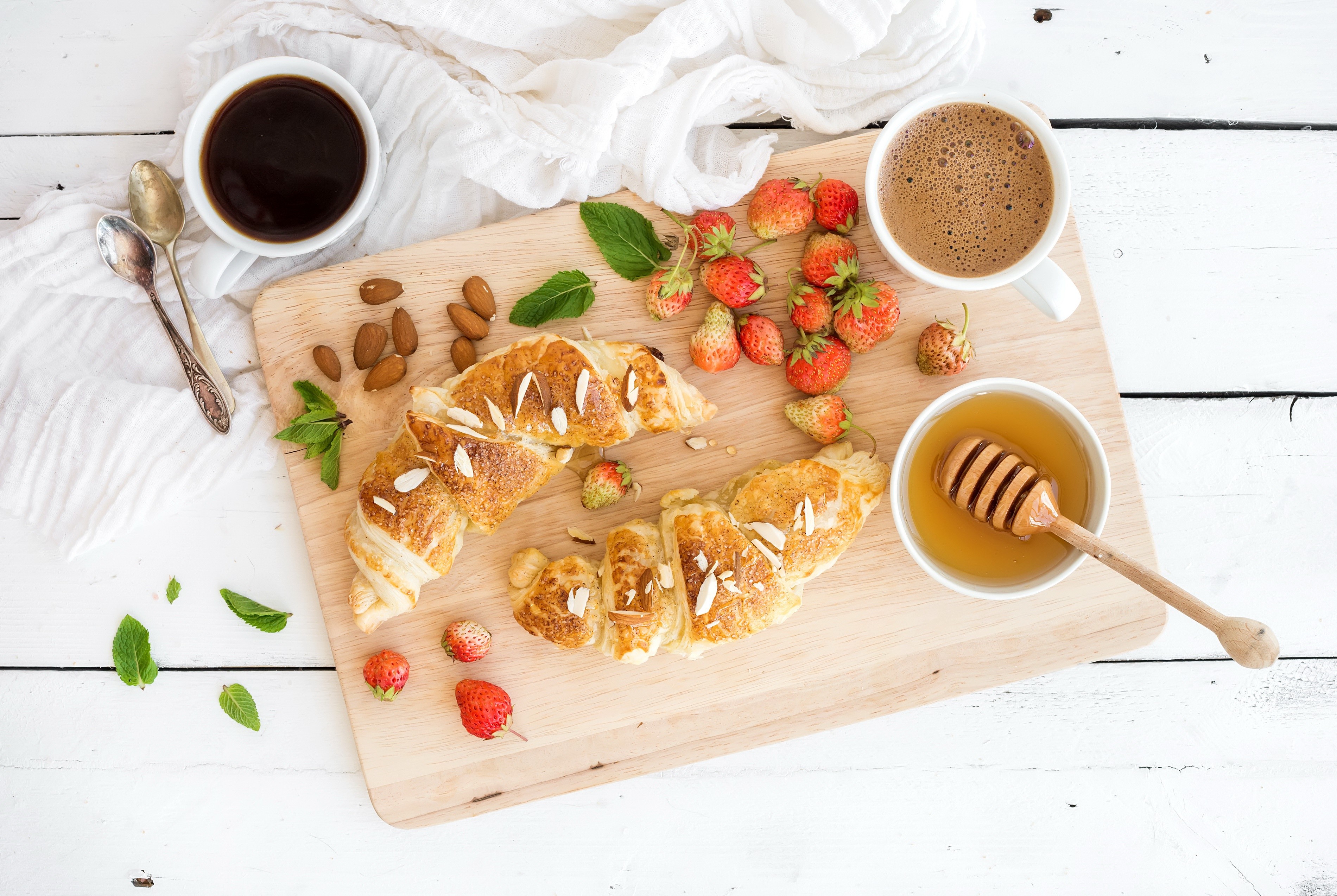 Croissant, strawberries, honey, and coffee on a wooden tray HD Wallpaper