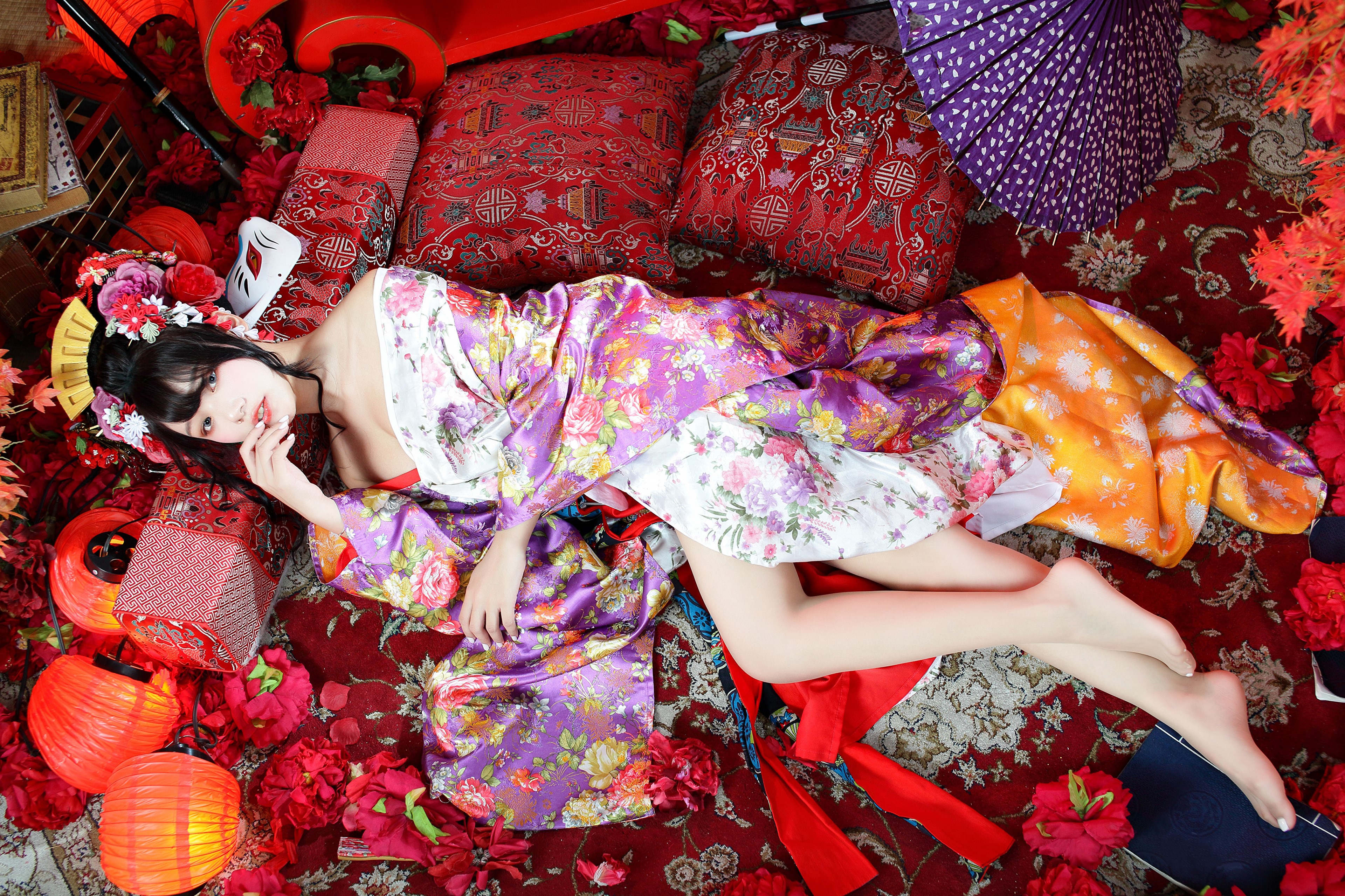 Brunette girl in kimono lying down with pillows HD Wallpaper