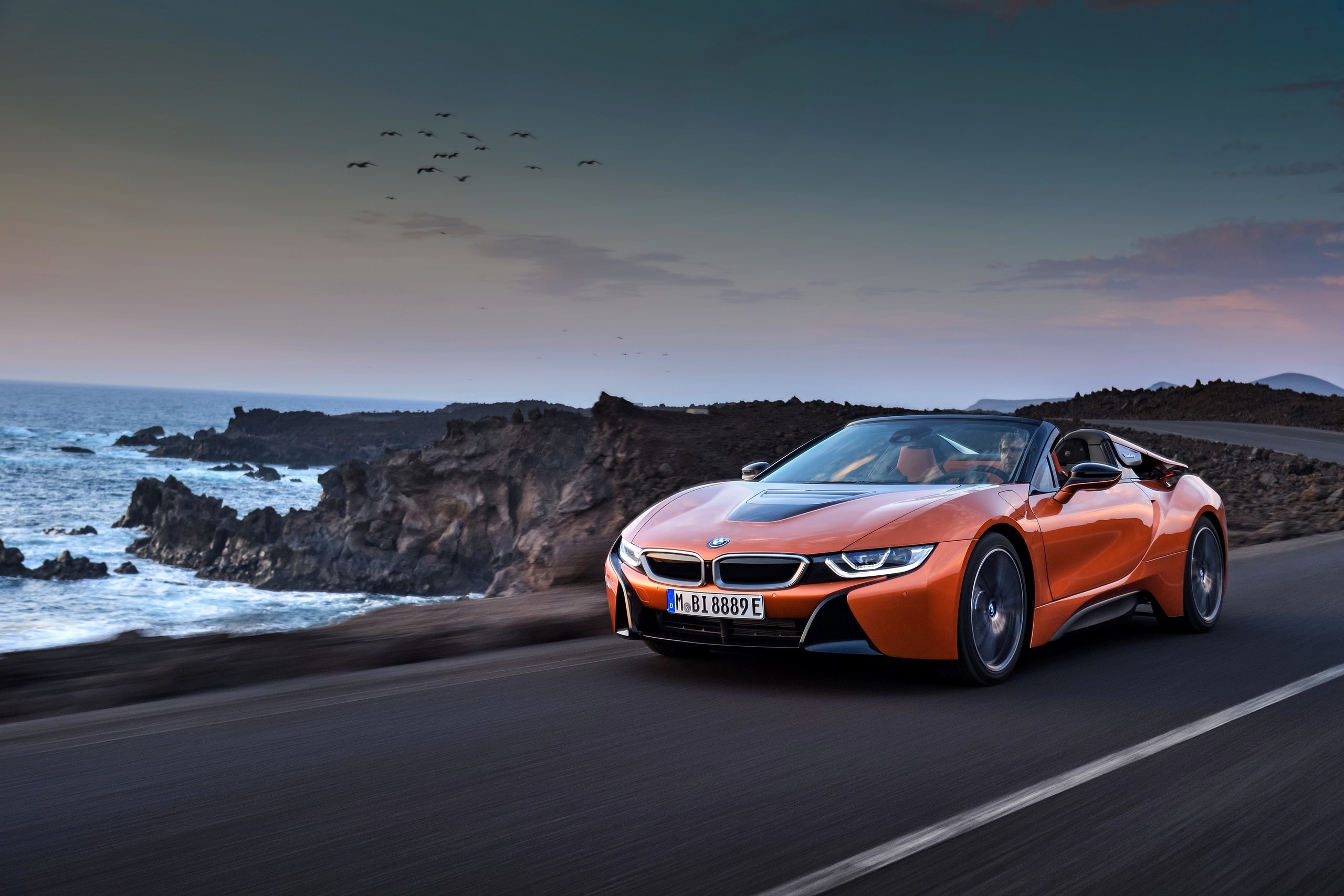 2018 BMW i8 Roadster driving on coastal road HD Wallpaper