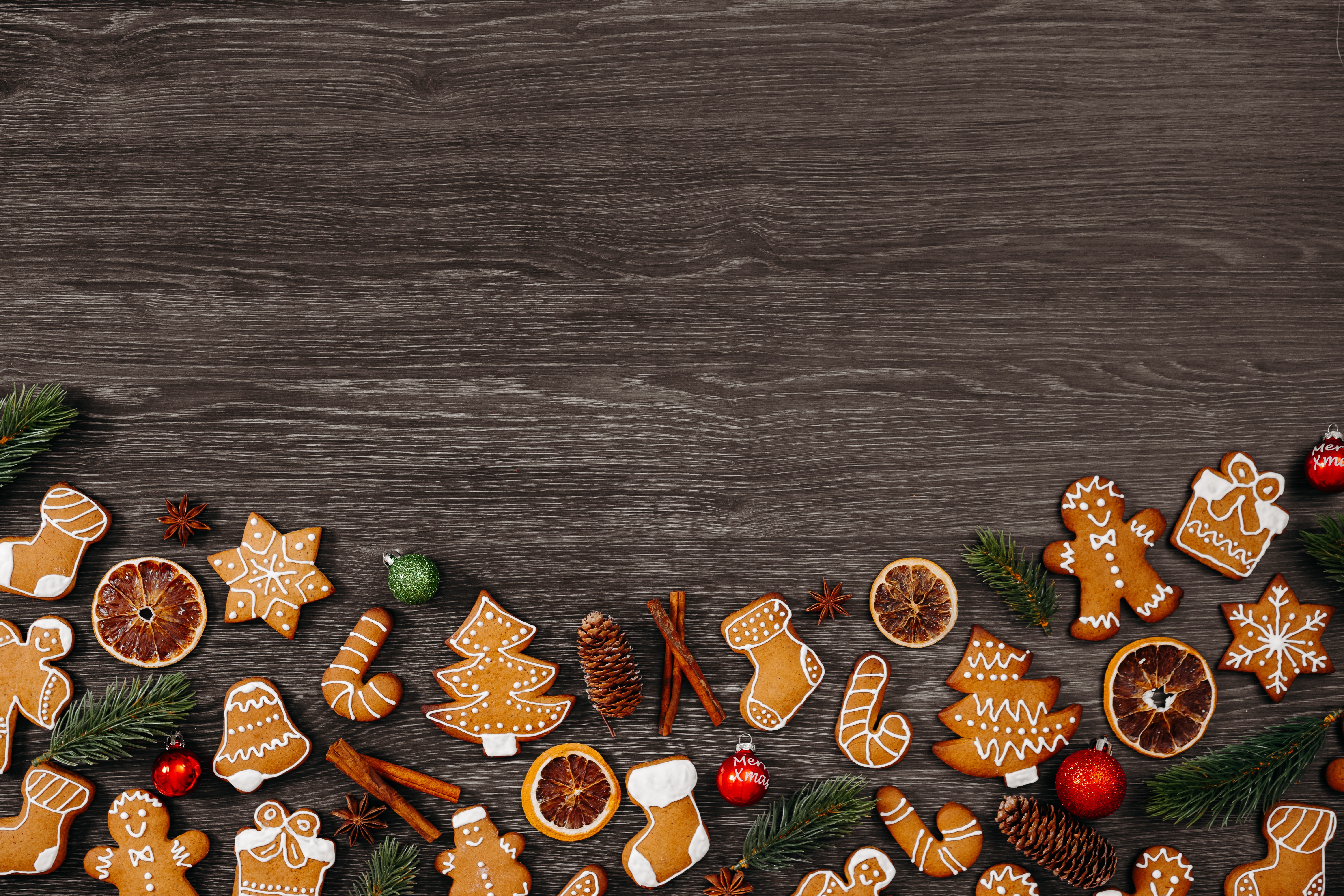 Christmas gingerbread cookies and decorations on dark wood HD Wallpaper