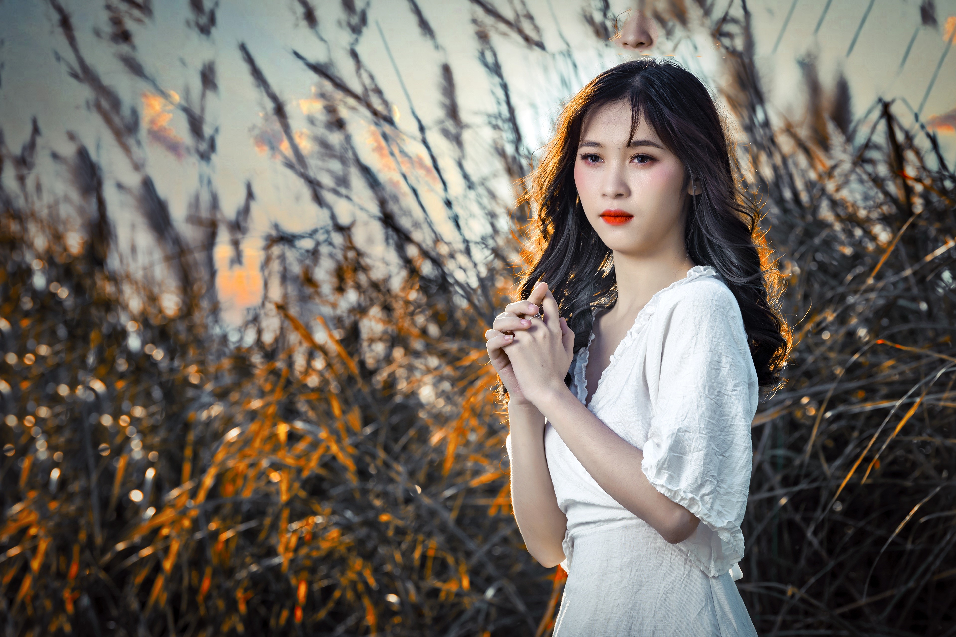 Brunette Asian girl in white dress with hands clasped HD Wallpaper