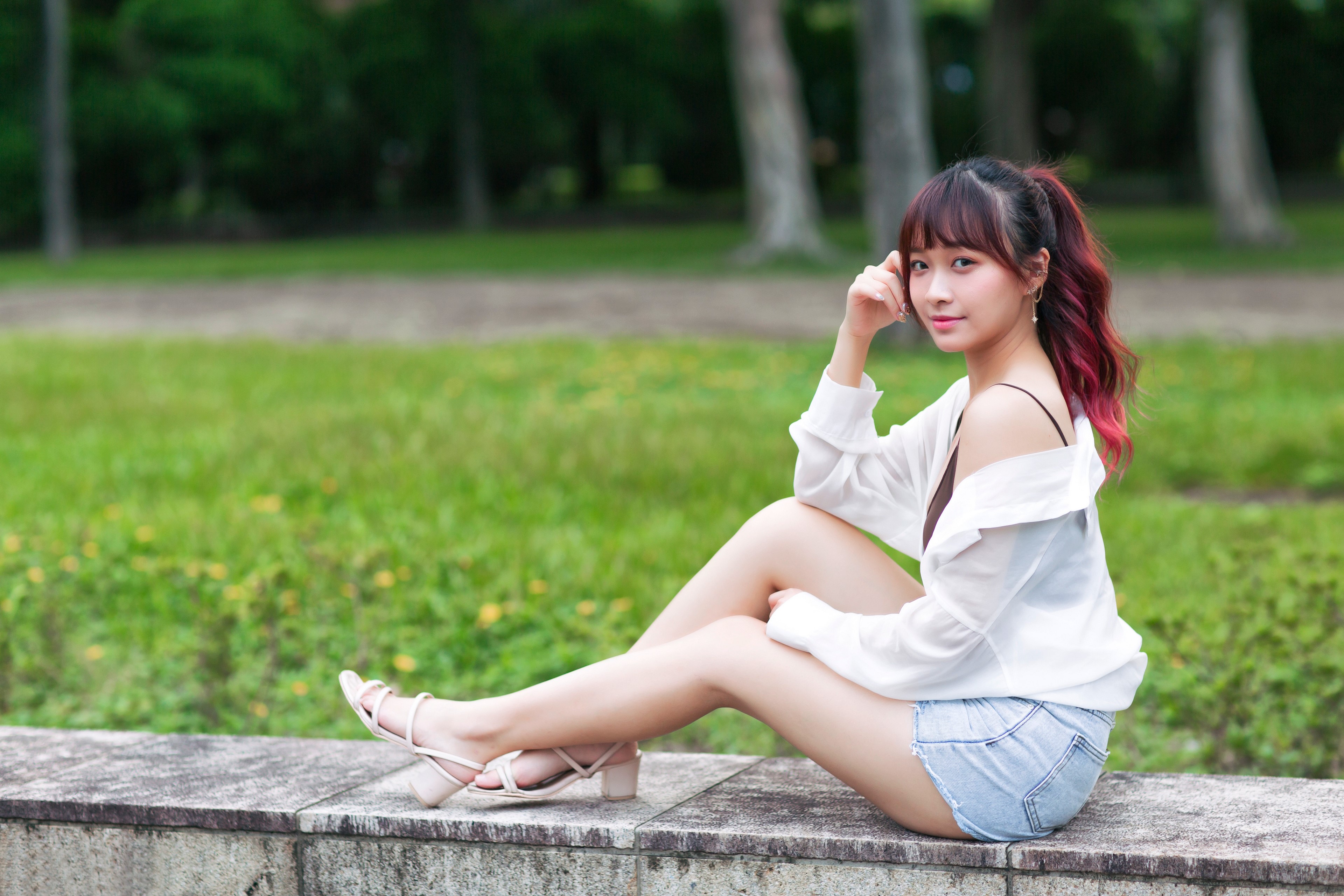 Asian woman sitting on a wall HD Wallpaper
