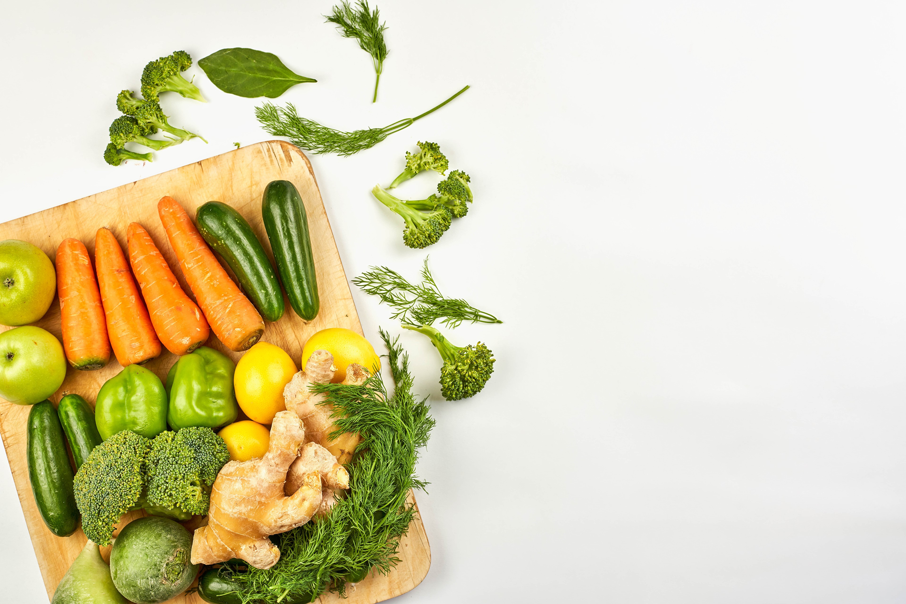 Vegetables and fruits on a cutting board HD Wallpaper