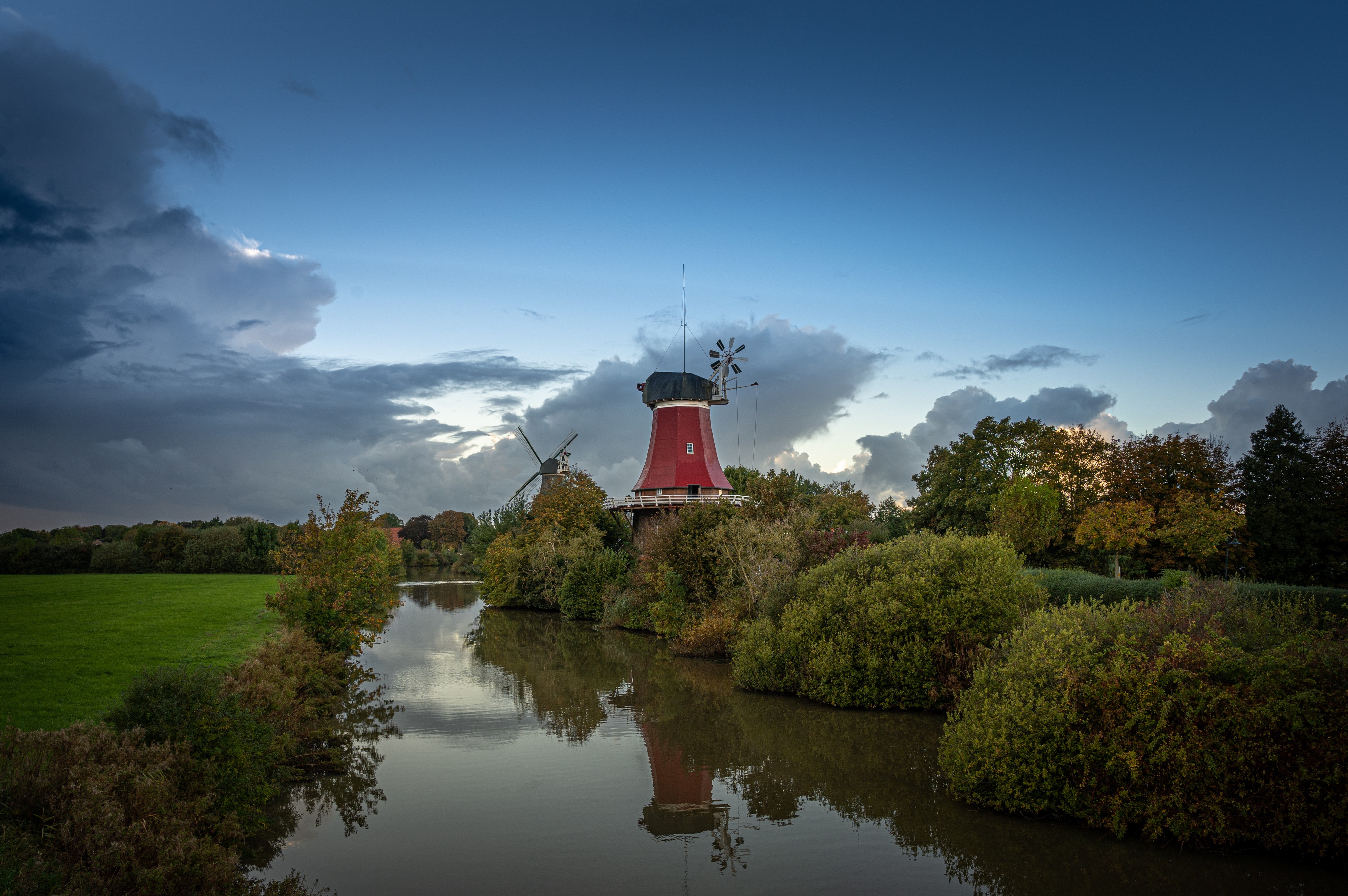Two windmills by a canal in Germany HD Wallpaper