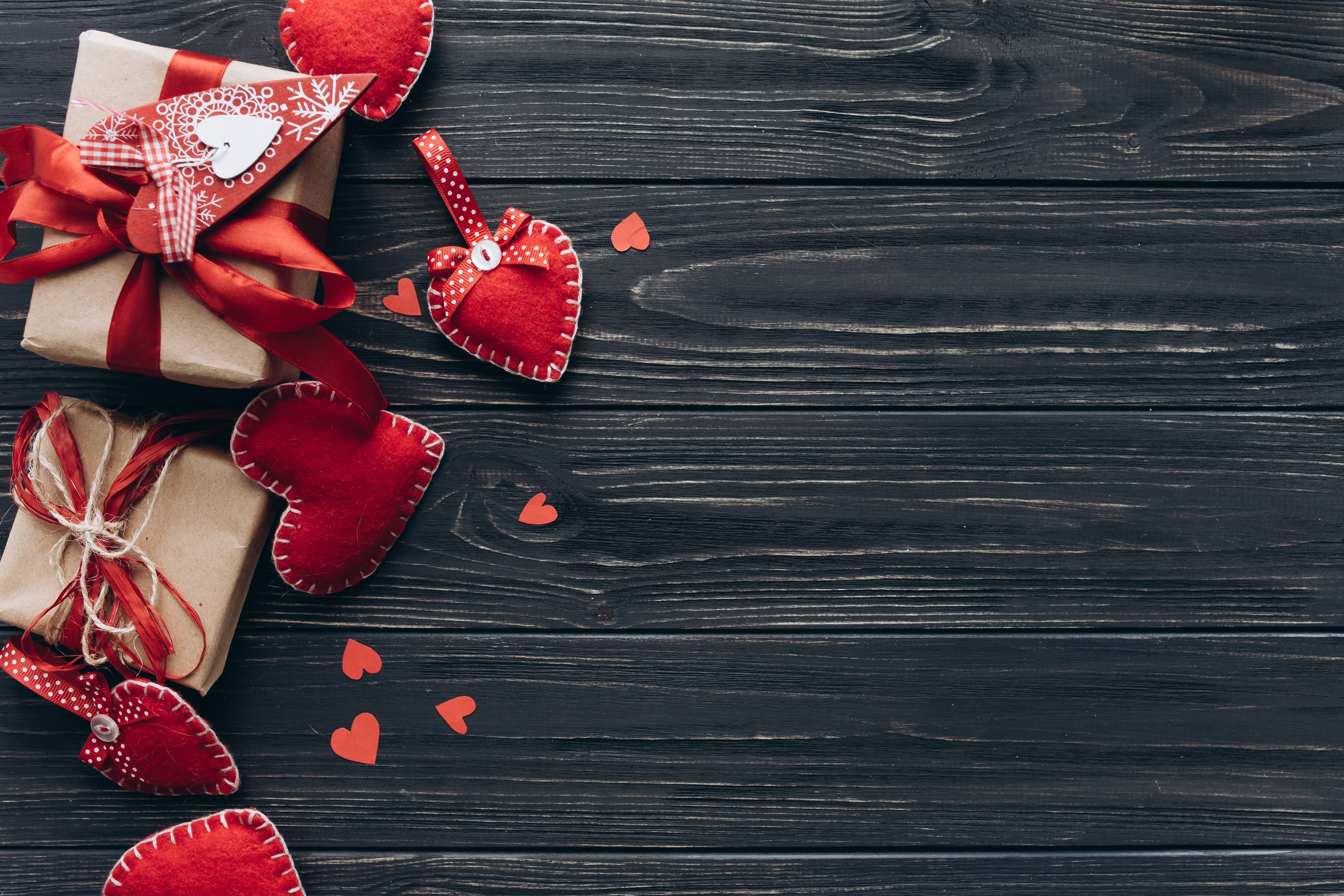 Valentine's Day gifts and hearts on a dark wooden background HD Wallpaper