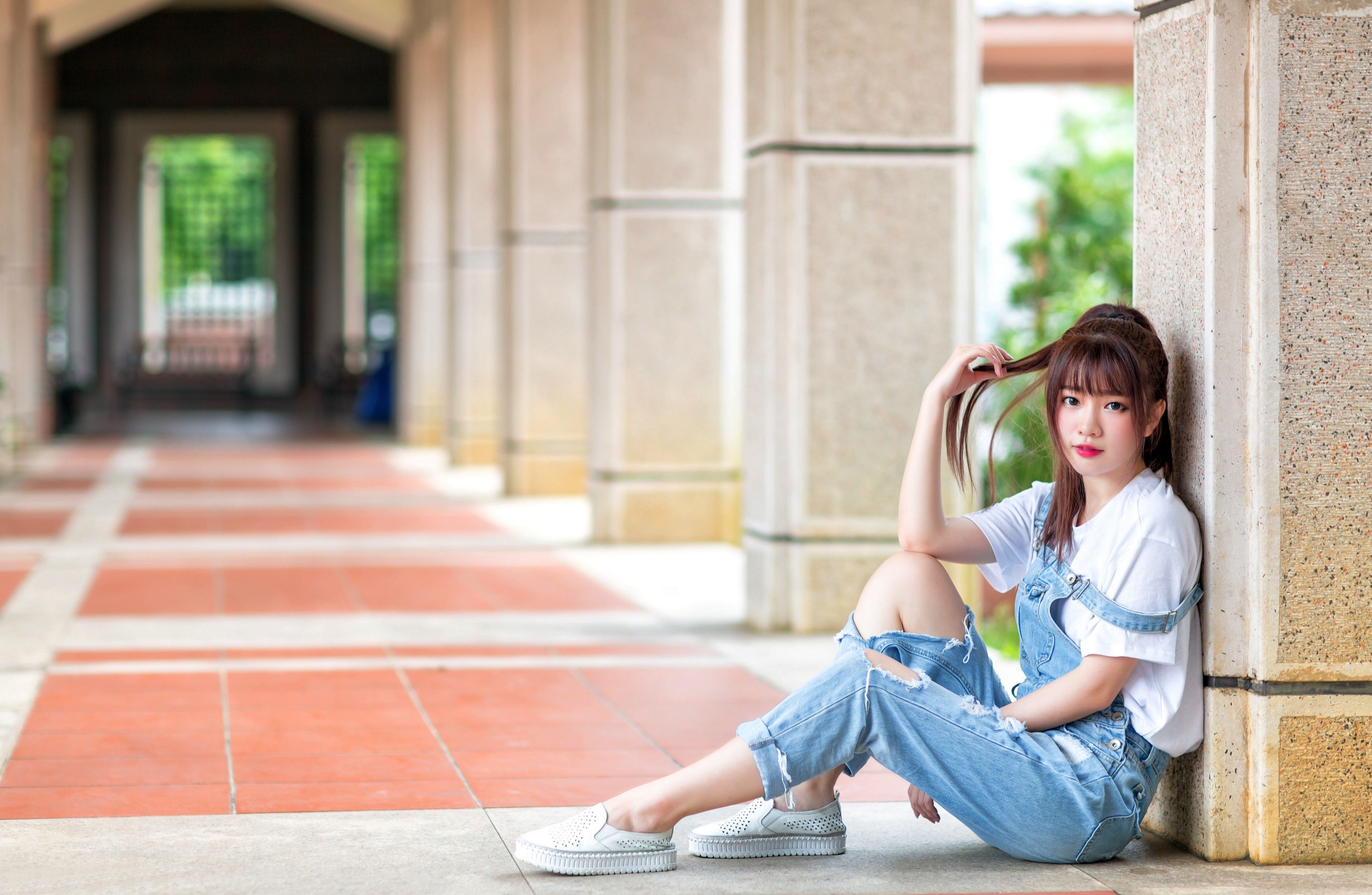 Asian woman with brown hair sitting in a hallway HD Wallpaper