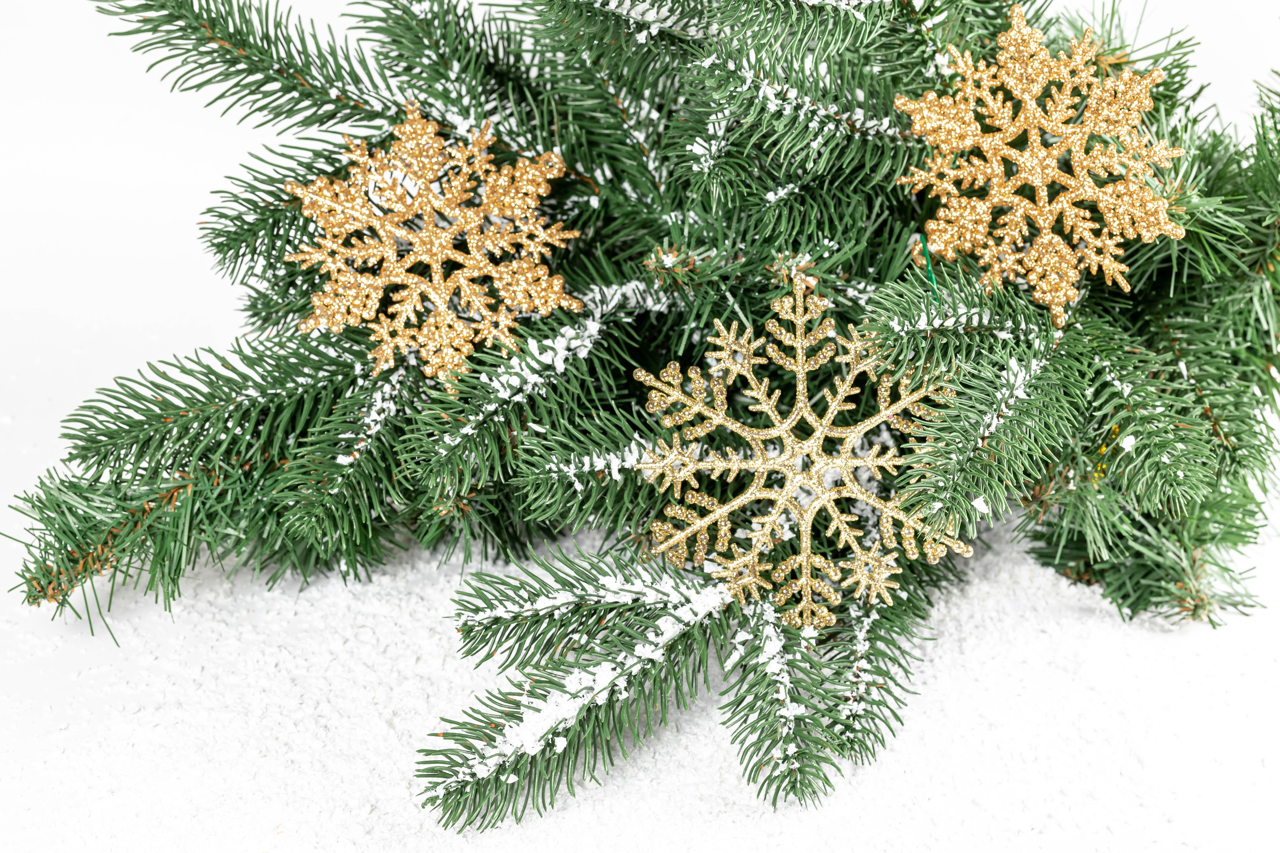 Christmas tree branches with golden snowflakes and snow HD Wallpaper