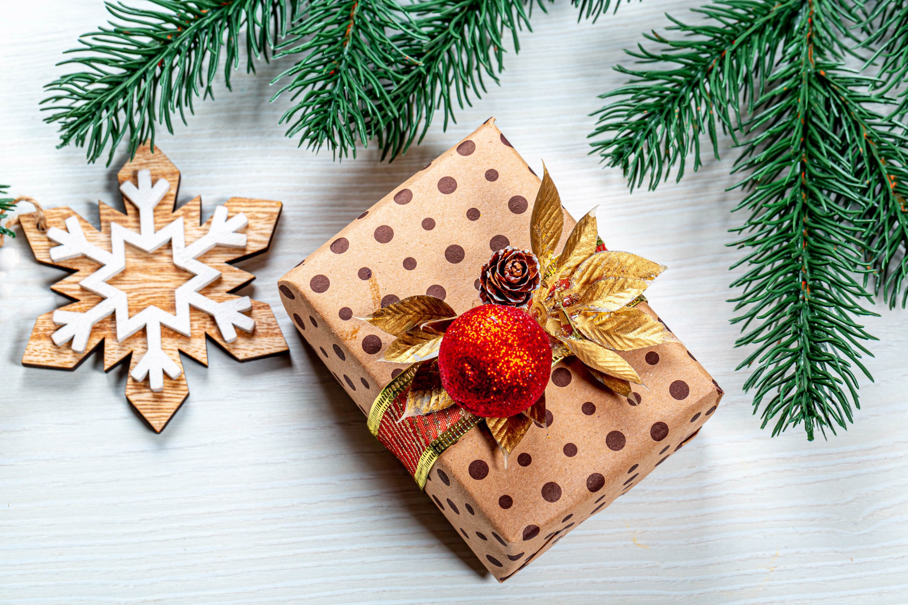 Christmas gift with snowflake and pine branches HD Wallpaper