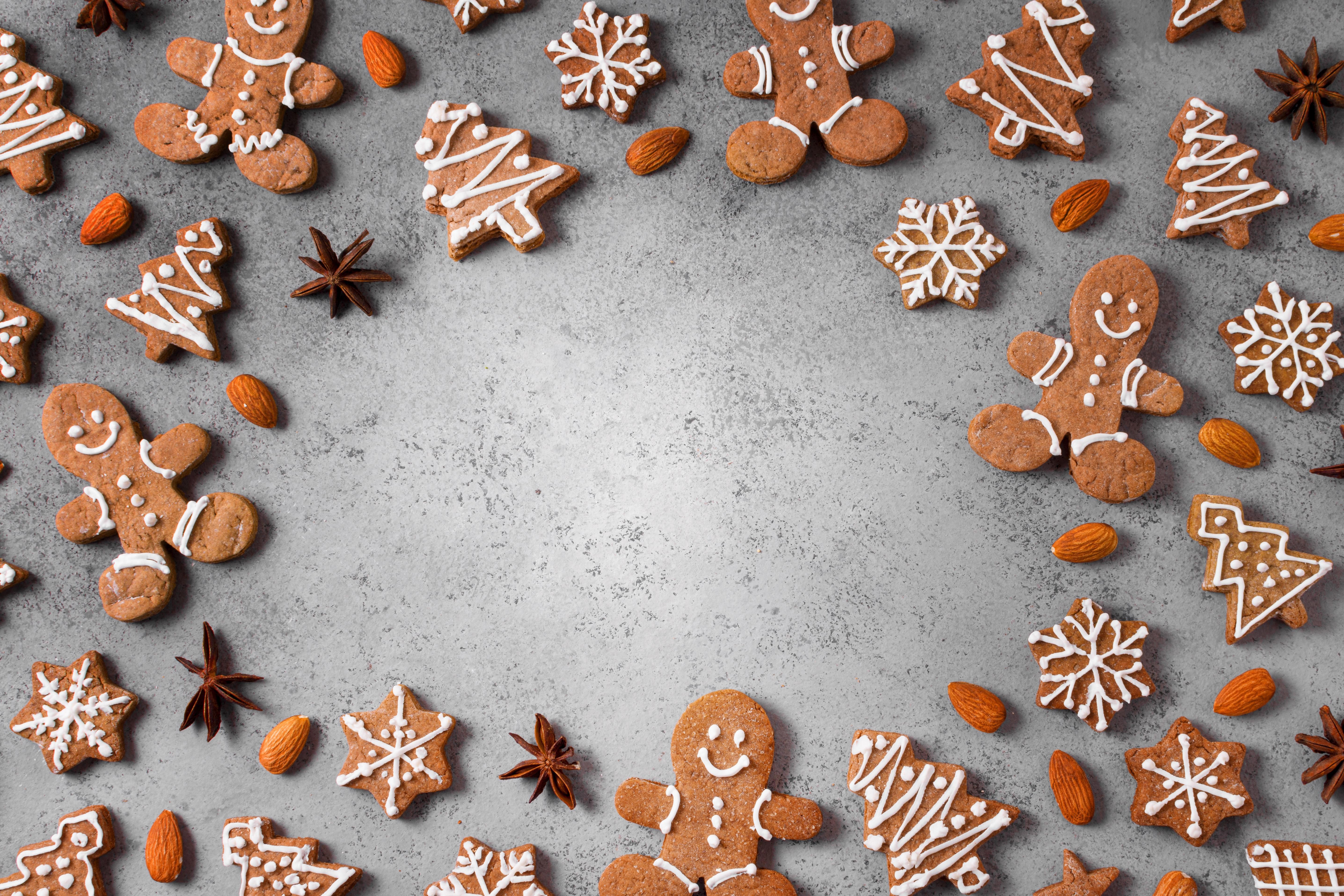 Christmas gingerbread cookies and almonds on a gray background HD Wallpaper