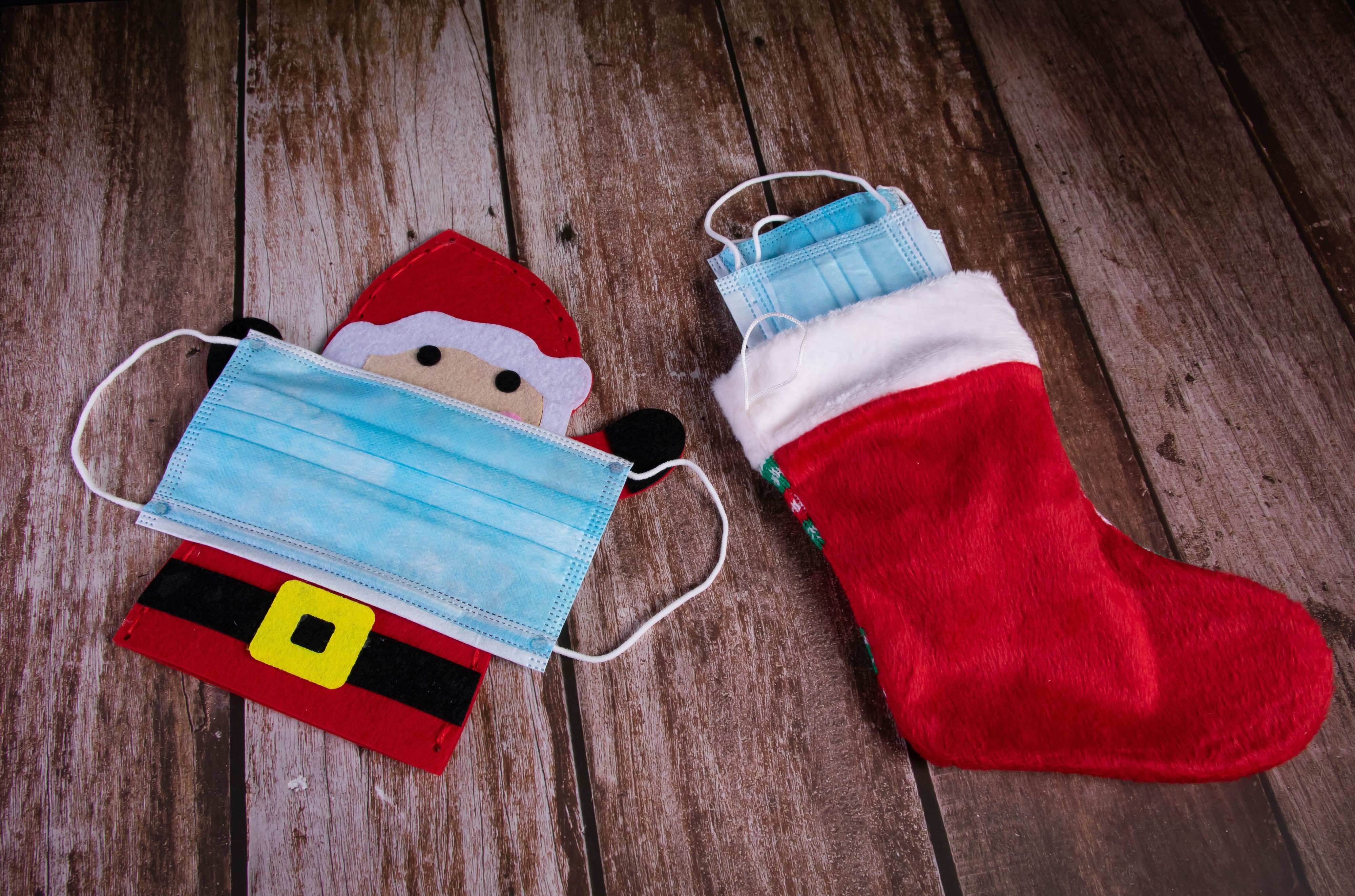 Santa Claus and Christmas stocking with masks HD Wallpaper