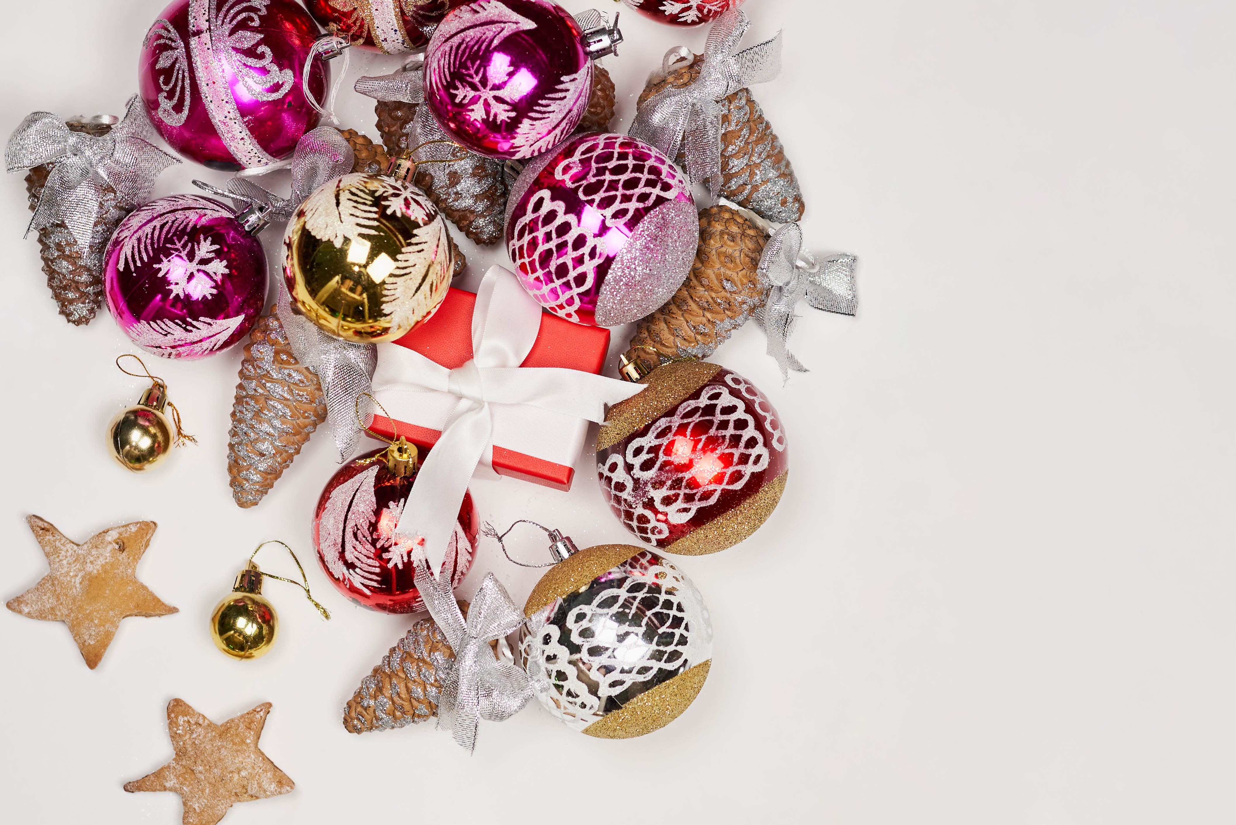 Christmas ornaments, pine cones, gift box, and cookies HD Wallpaper