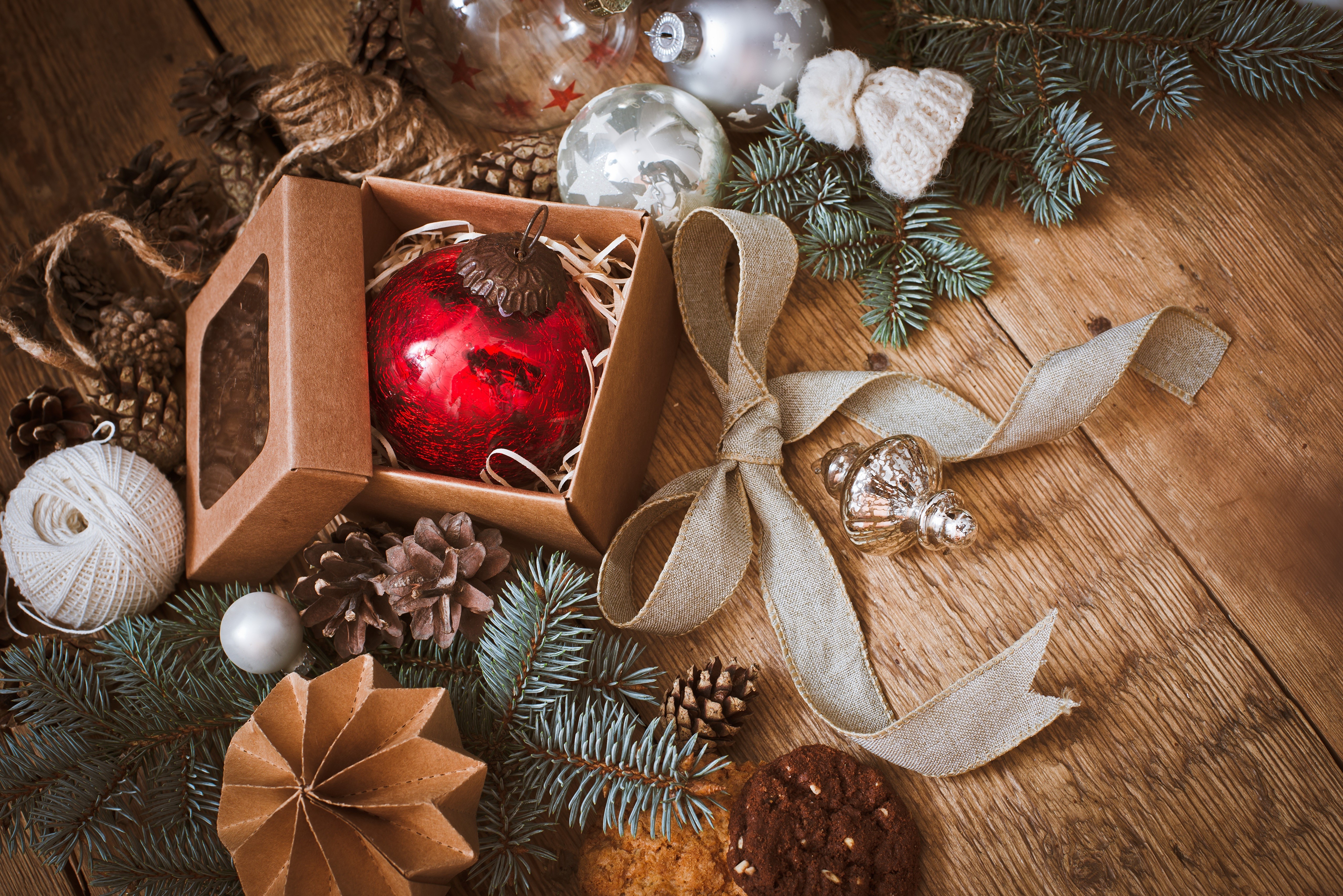 Christmas ornaments and pine cones on wooden table HD Wallpaper