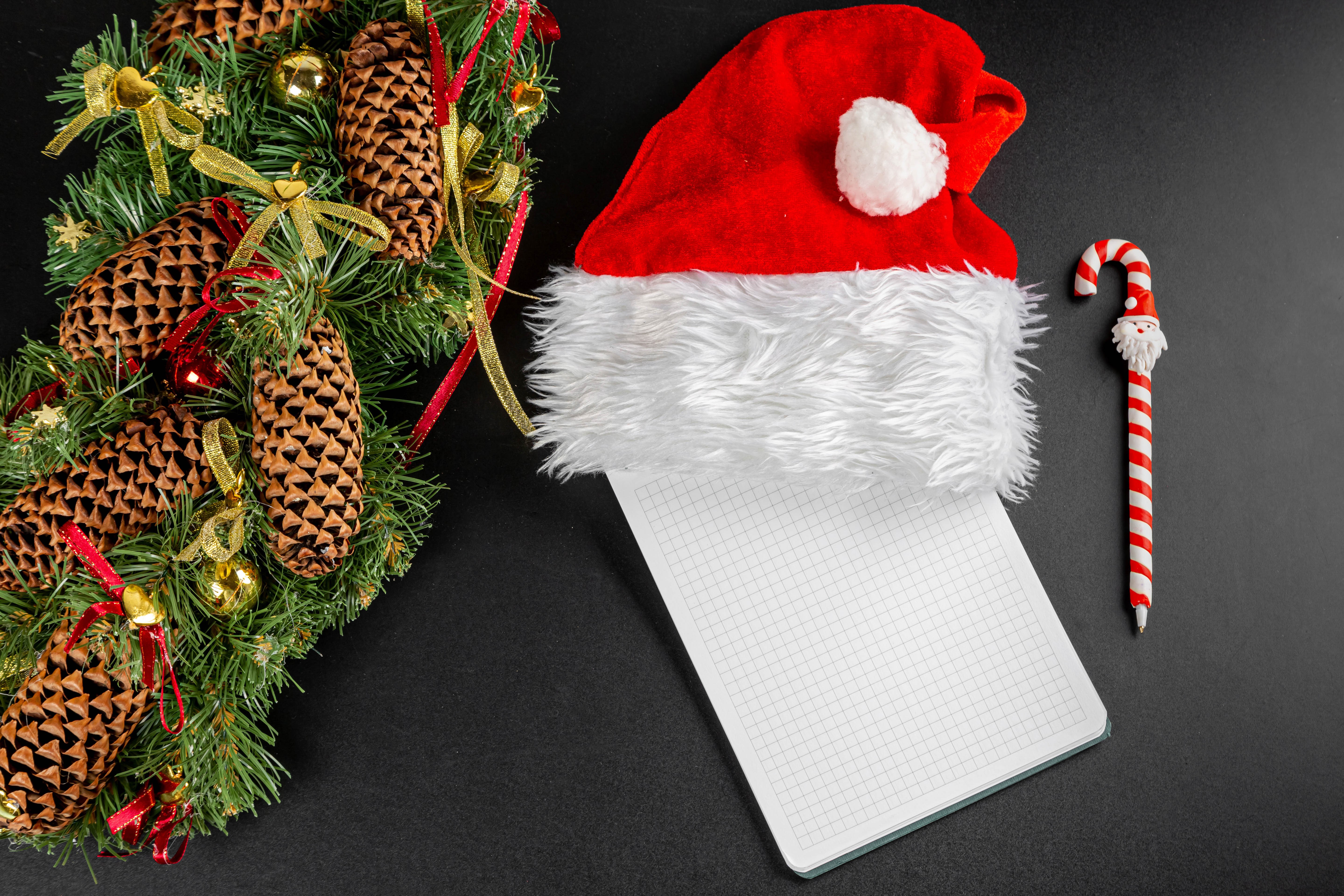 Christmas wreath, Santa hat, notebook, and candy cane pen HD Wallpaper