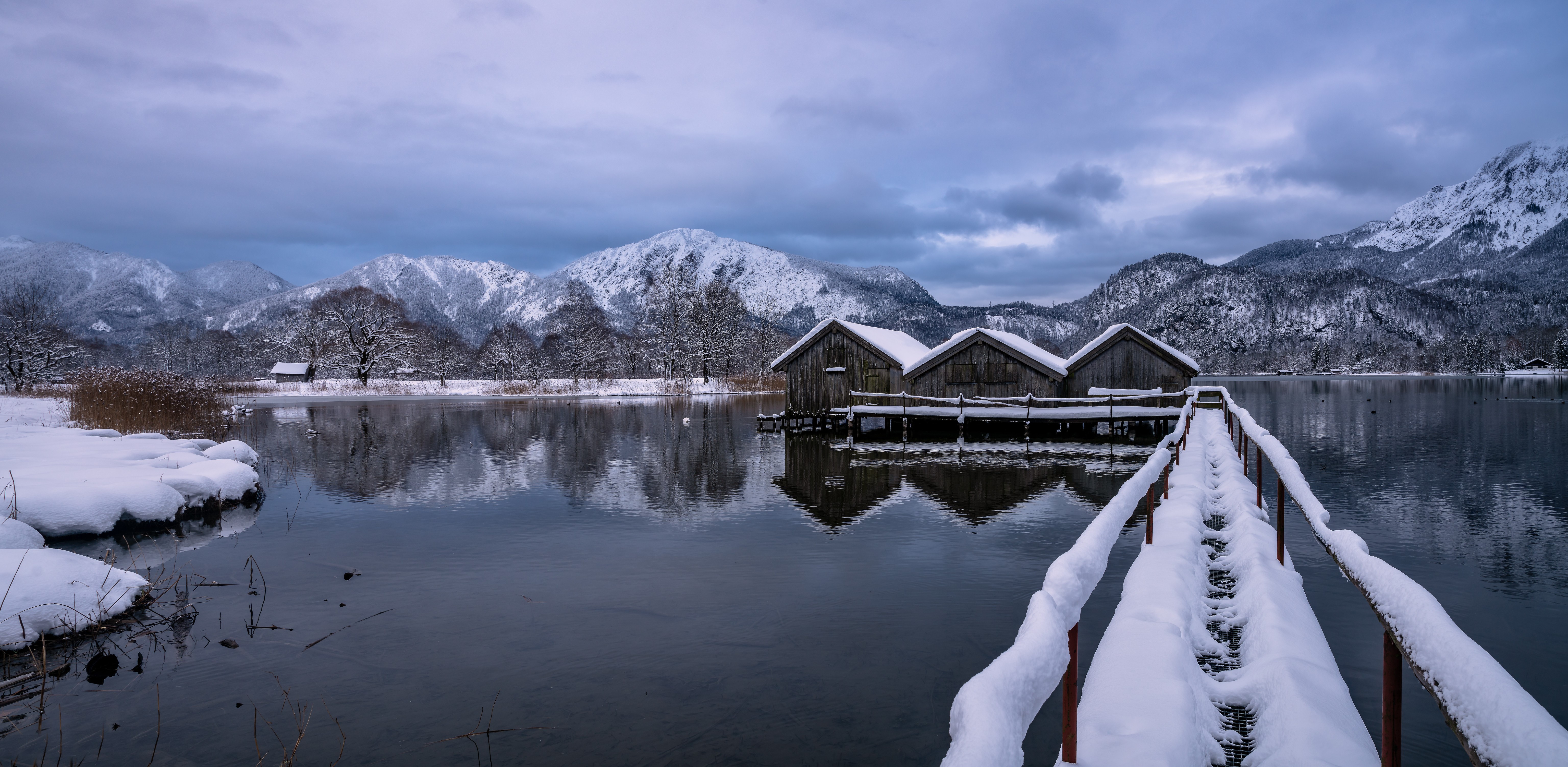 Boathouses on a snowy lake in the Bavarian Alps HD Wallpaper