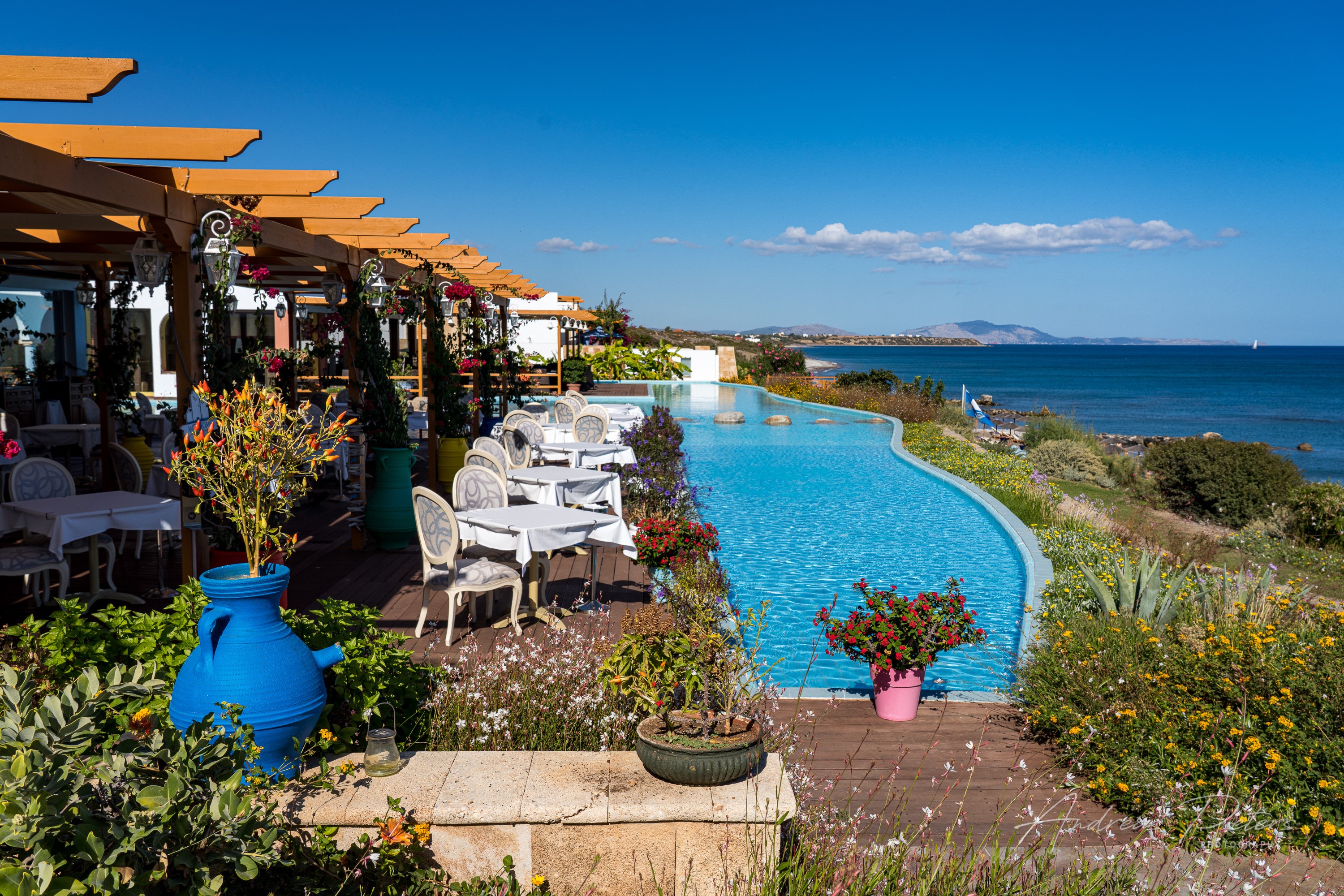 Restaurant with infinity pool overlooking the sea in Lachania, Greece HD Wallpaper