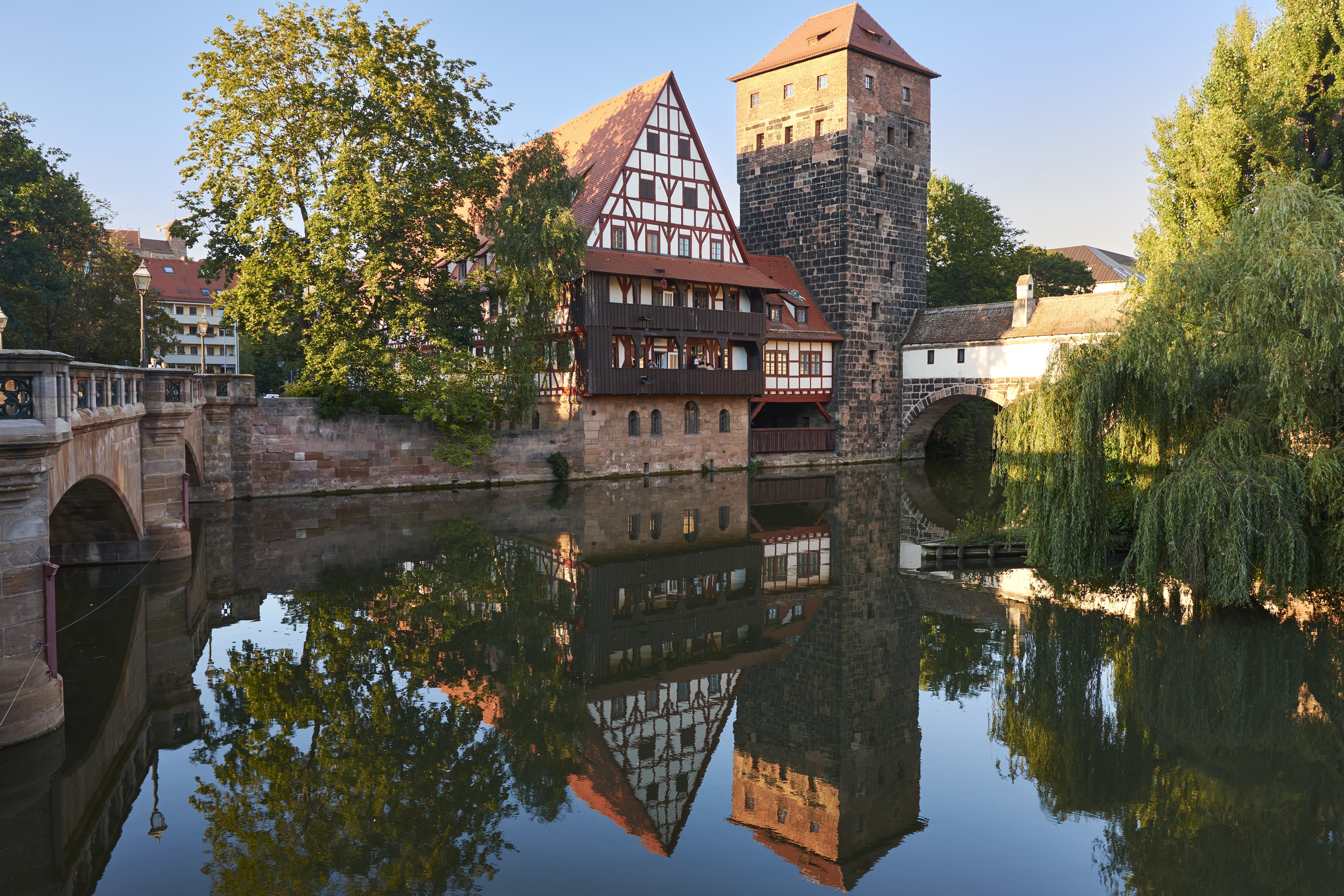 Half-timbered houses and tower reflected in a river in Nuremberg, Germany HD Wallpaper