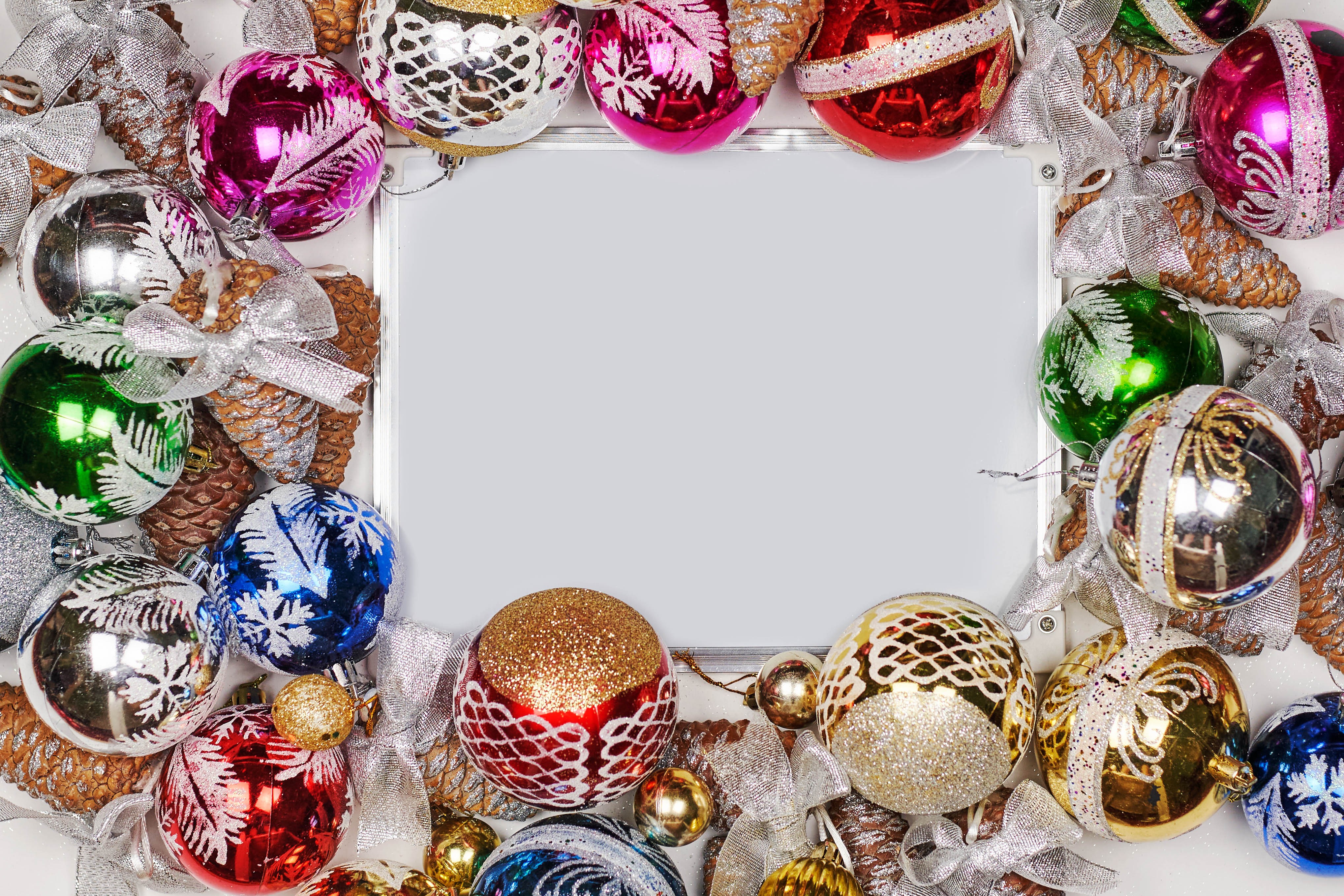 Christmas balls and pine cones frame a blank card HD Wallpaper